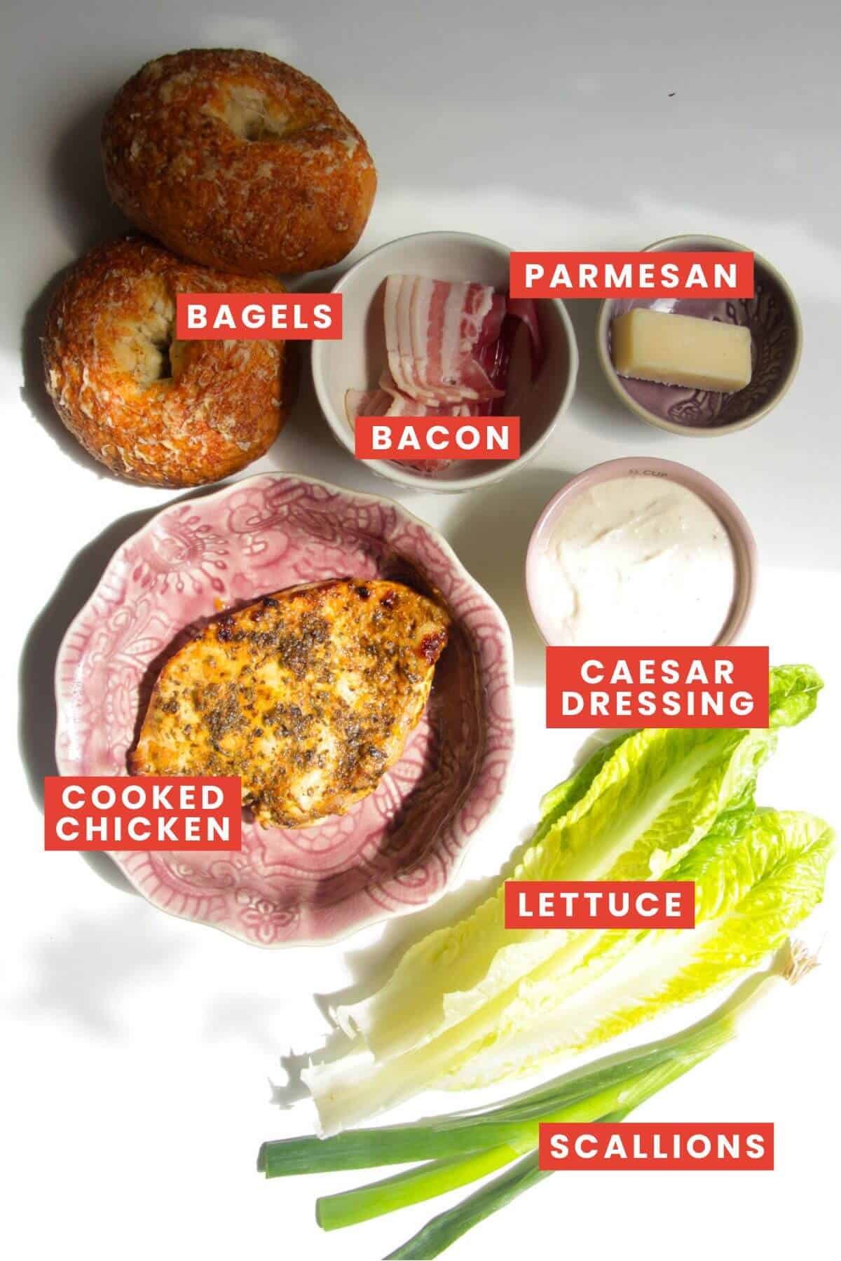 Ingredients for chopped chicken Caesar salad bagels laid out and labelled.