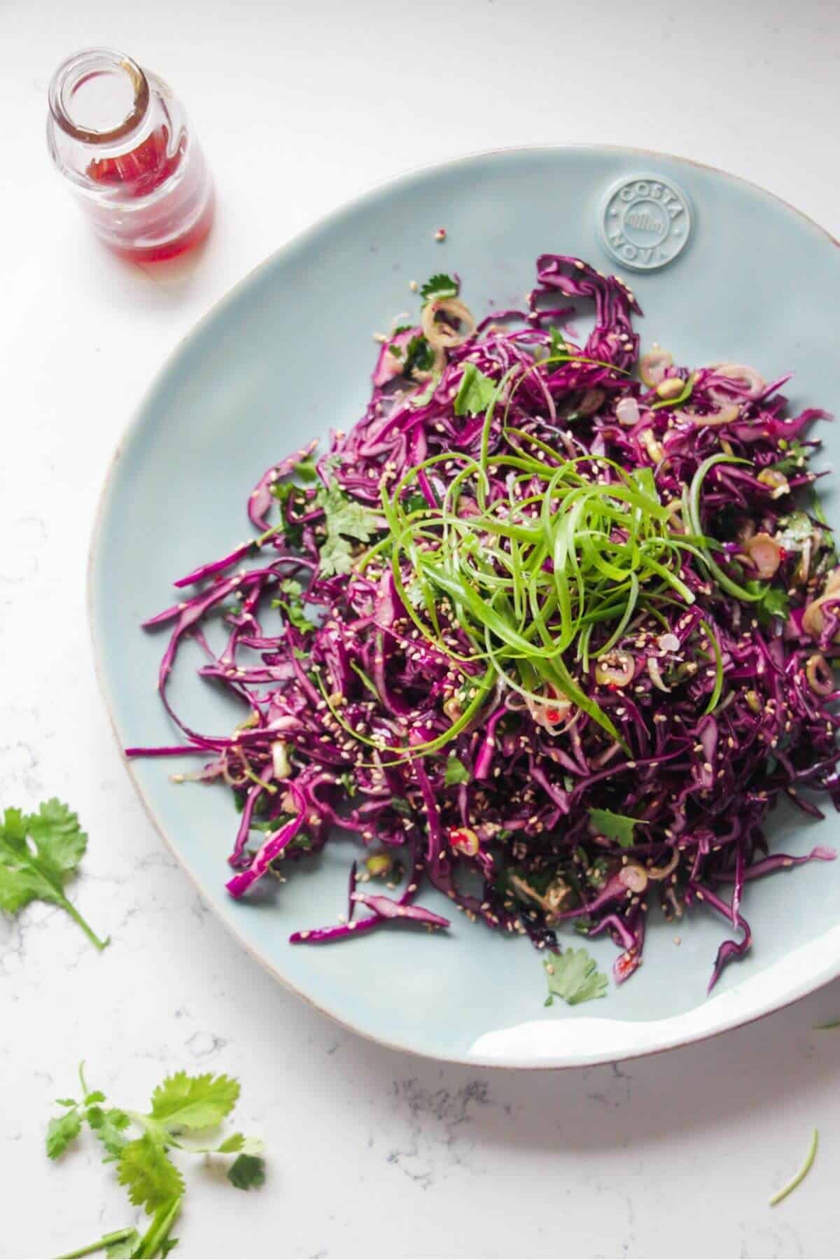 Crunchy Asian salad on a large light blue serving plate.