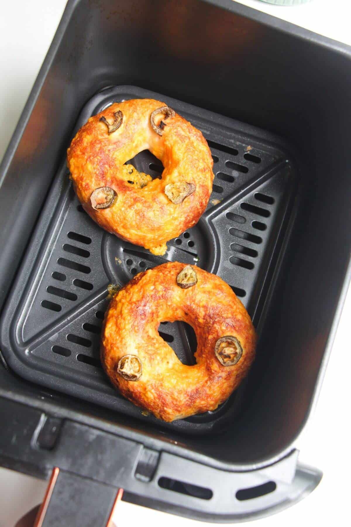Bagels baked in air fryer basket.