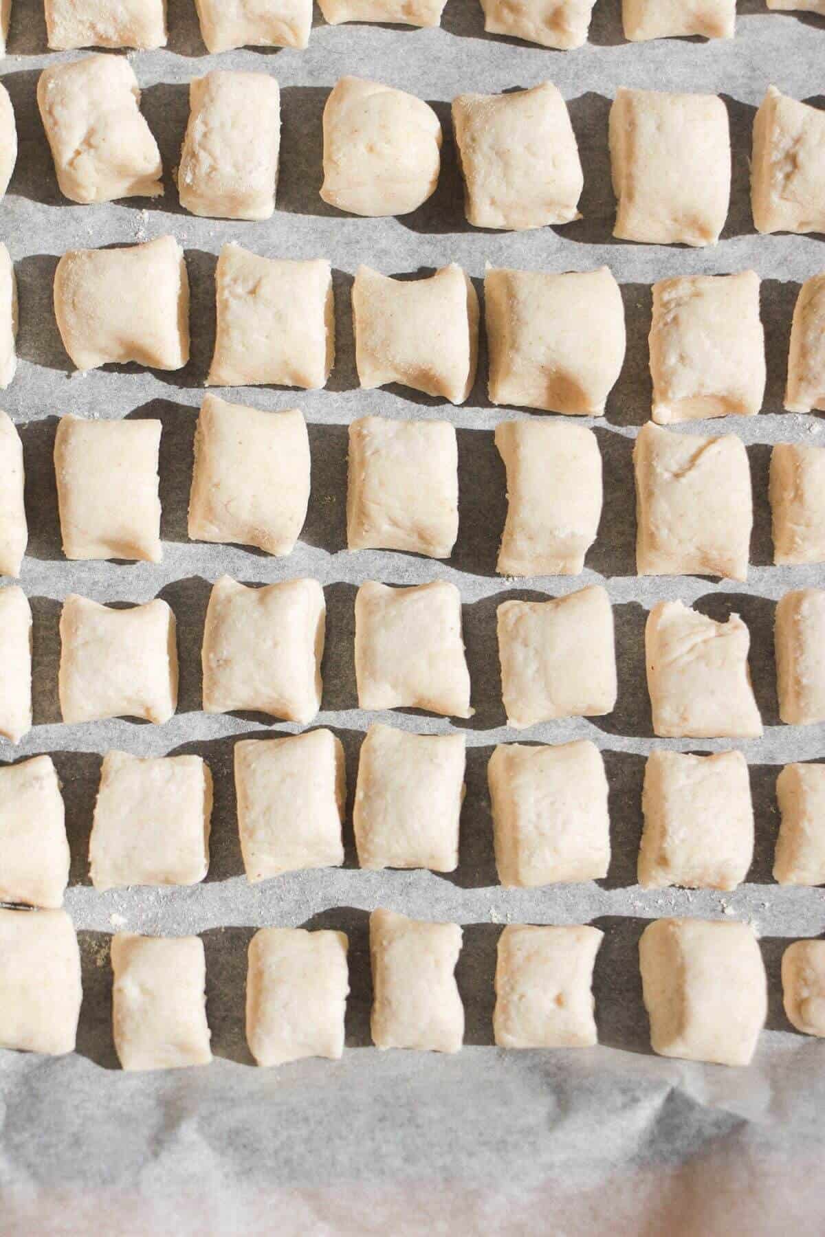 Cottage cheese gnocchi on a lined tray.