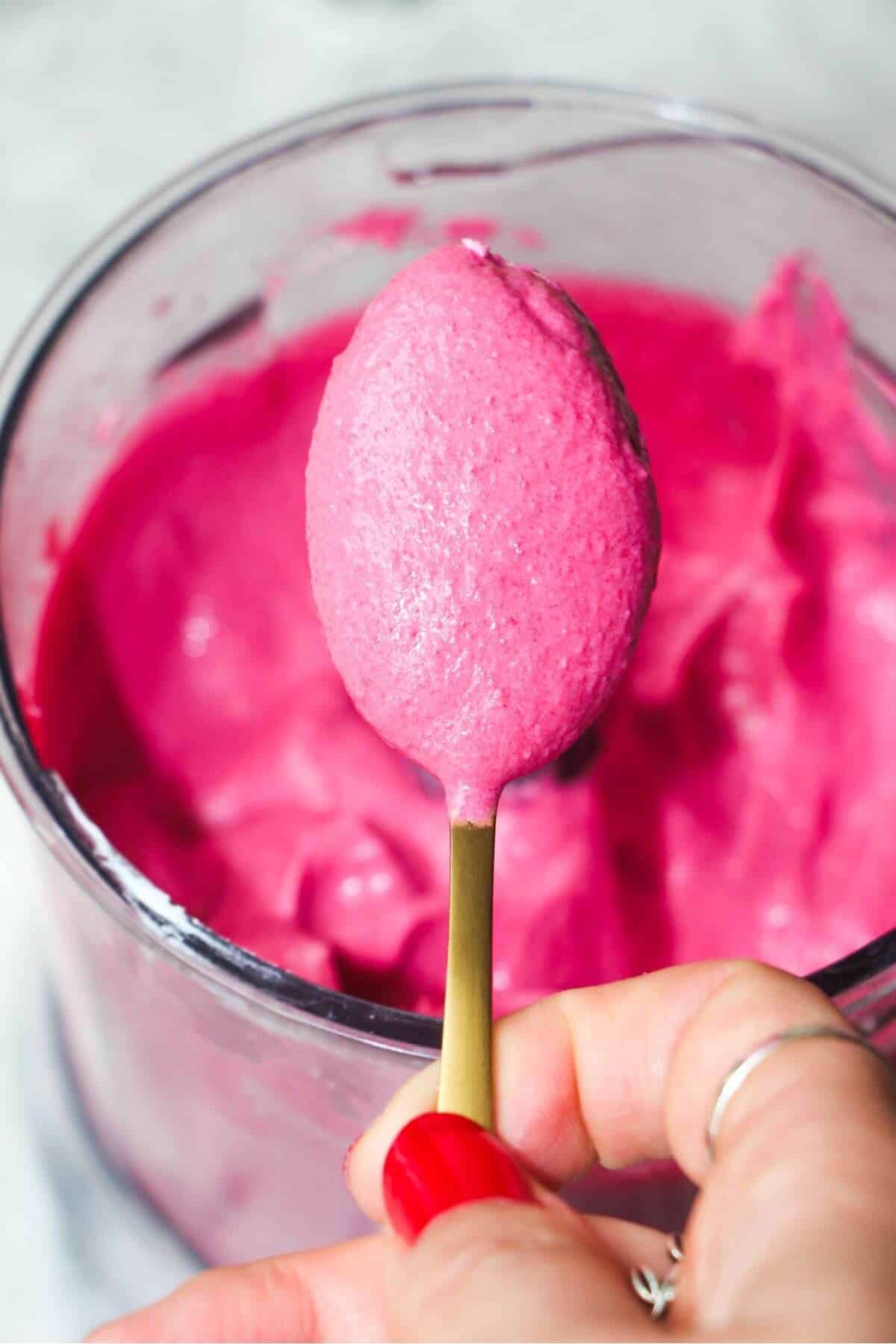 Smooth beetroot dip on a small gold spoon.