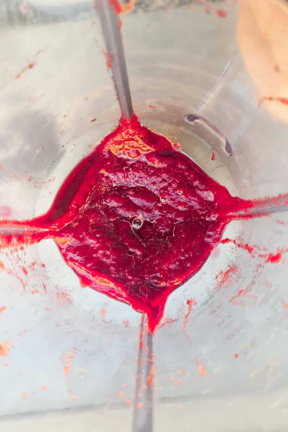 Bright pink beetroot puree in a blender.