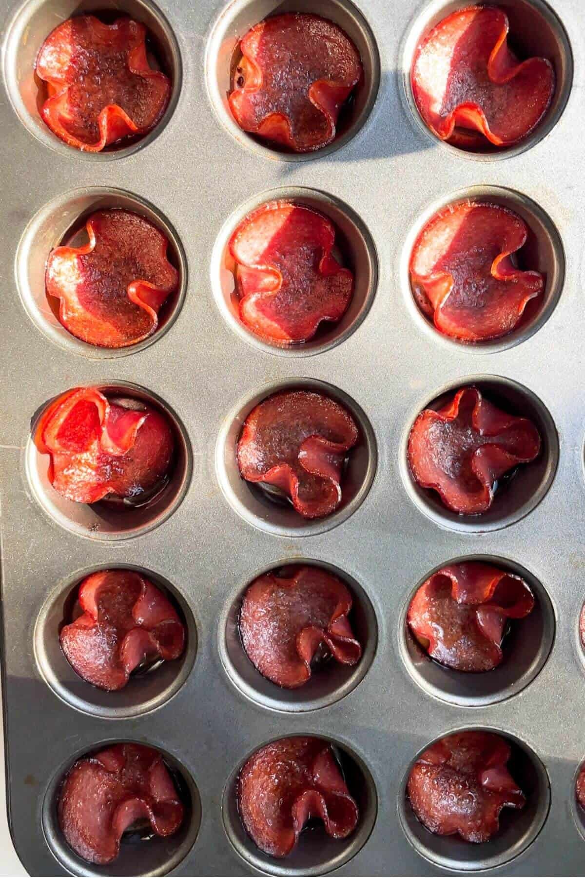 Crispy salami bites in a mini muffin tin.
