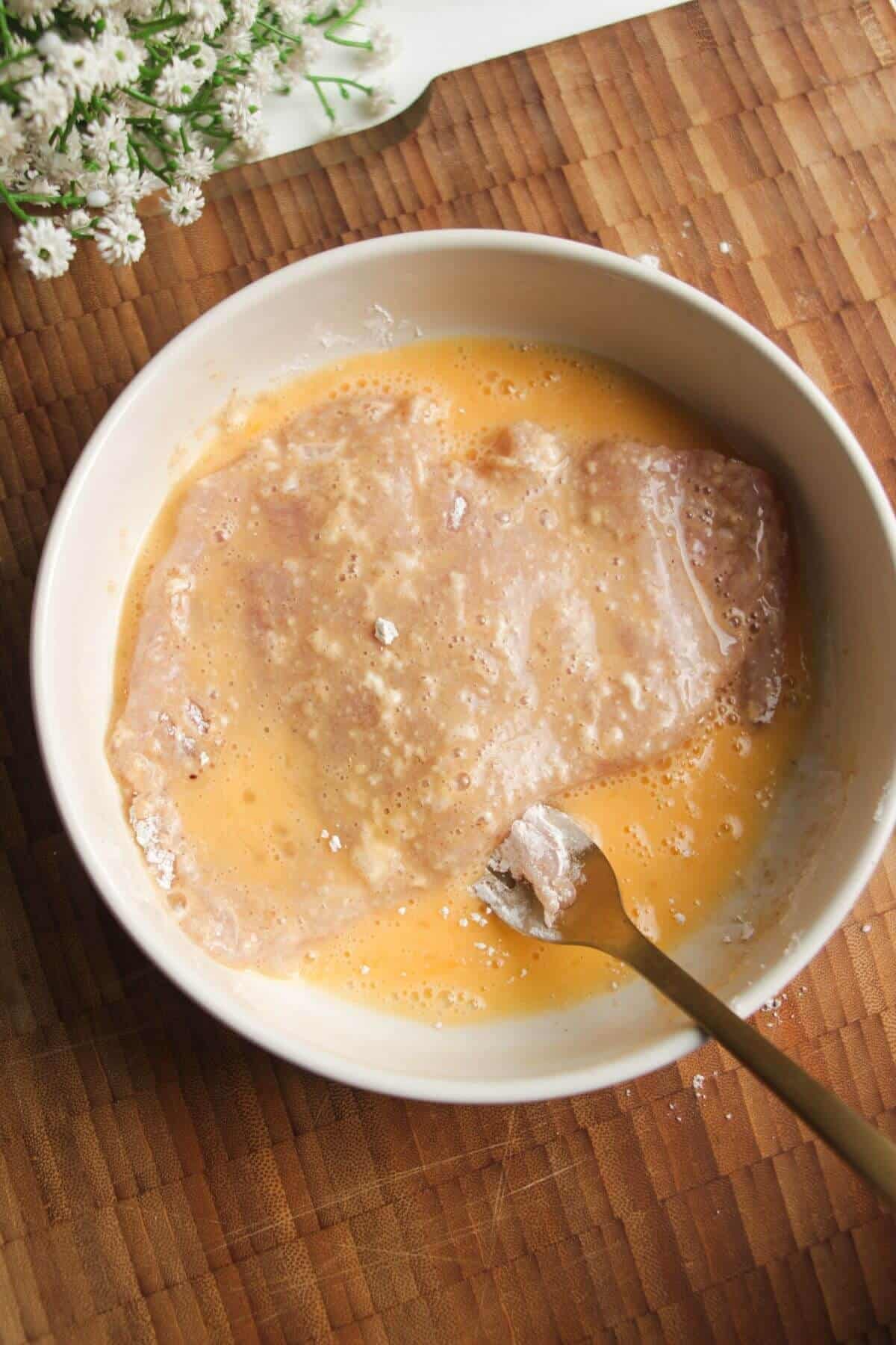 Chicken breast dipped in egg.