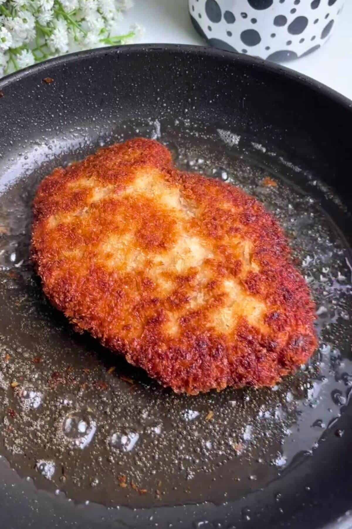 Crispy breaded chicken in a small pan.
