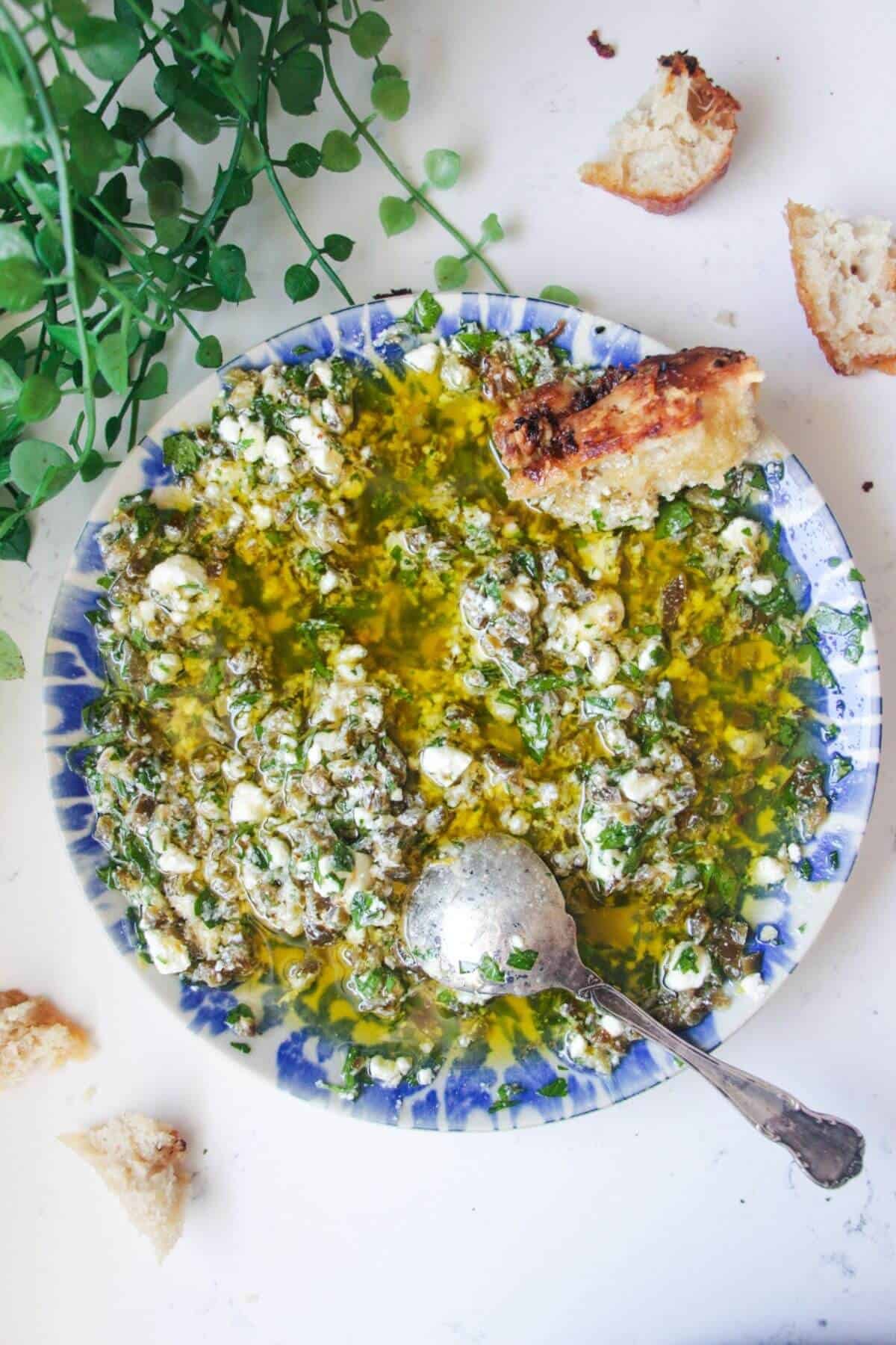 Jalapeno popper bread dipping oil on a blue and white patterned plate.