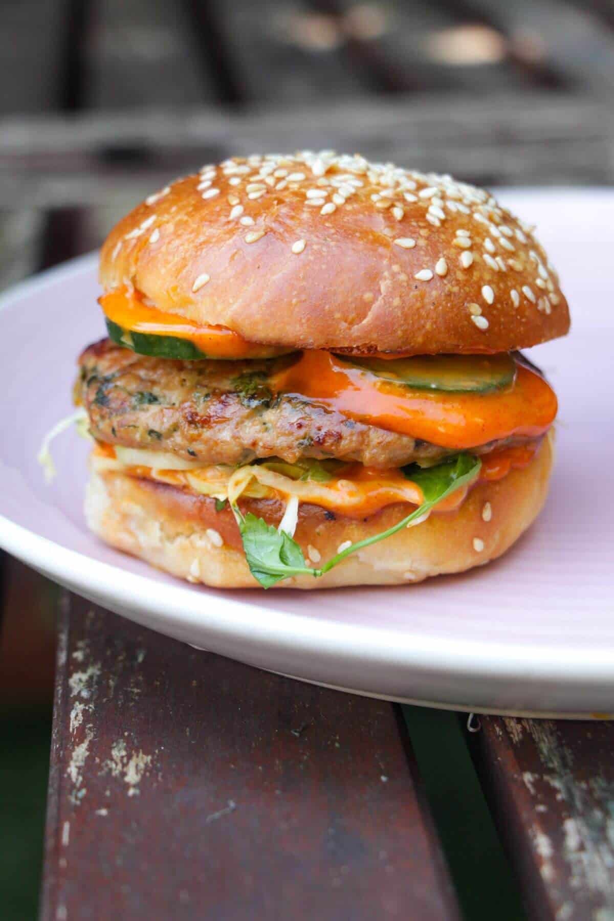 Dumpling burger on a pink plate.