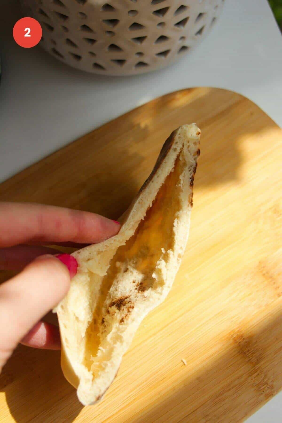 Hand holding open flatbread.