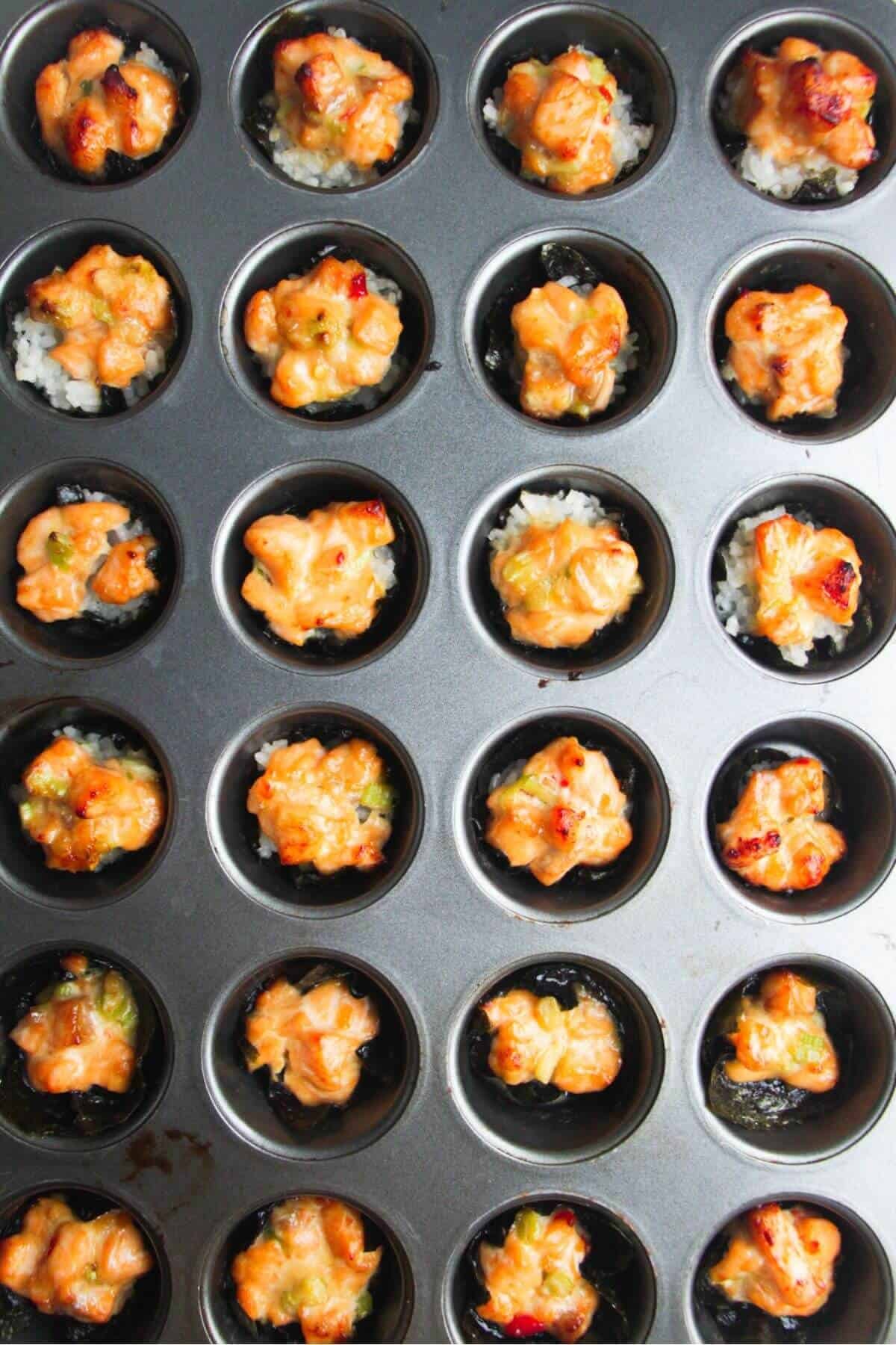 Baked salmon sushi cups in a mini muffin tin.
