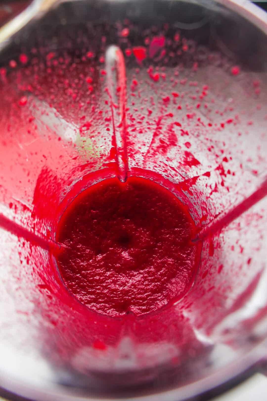 Beetroot puree after being blitzed in the bowl of a blender.