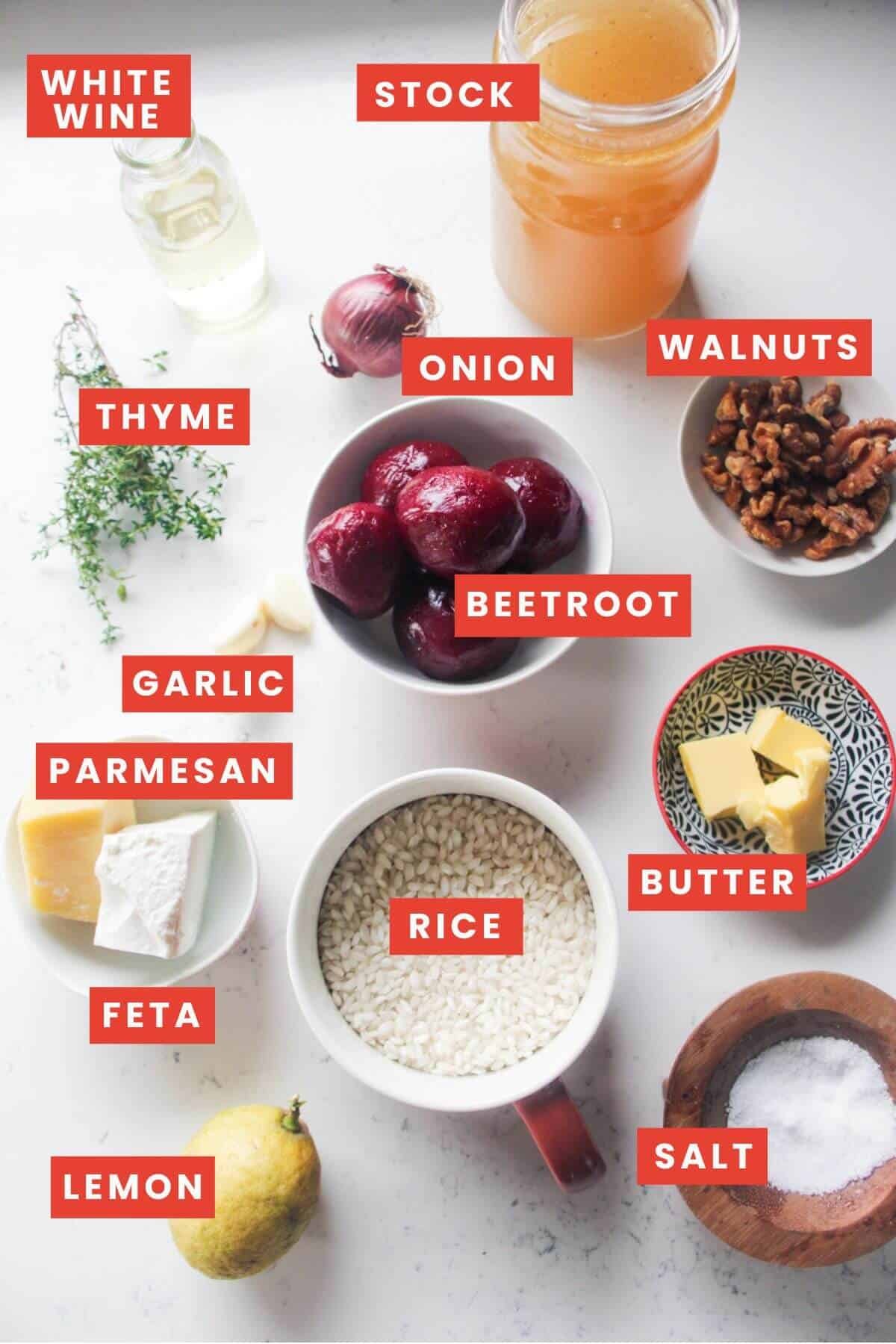 Ingredients for beetroot risotto laid out on a grey marble background and labelled.
