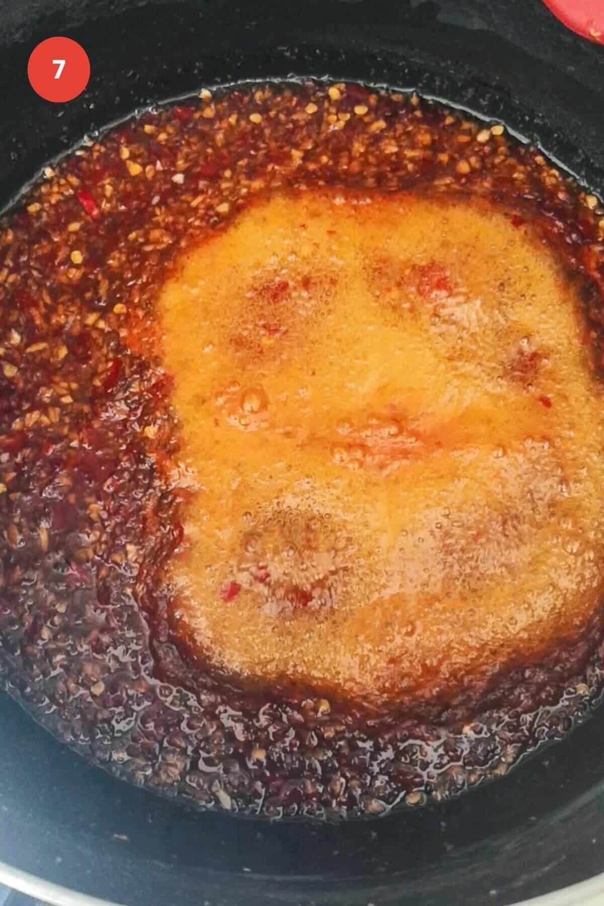 Chili jam bubbling in large pot.