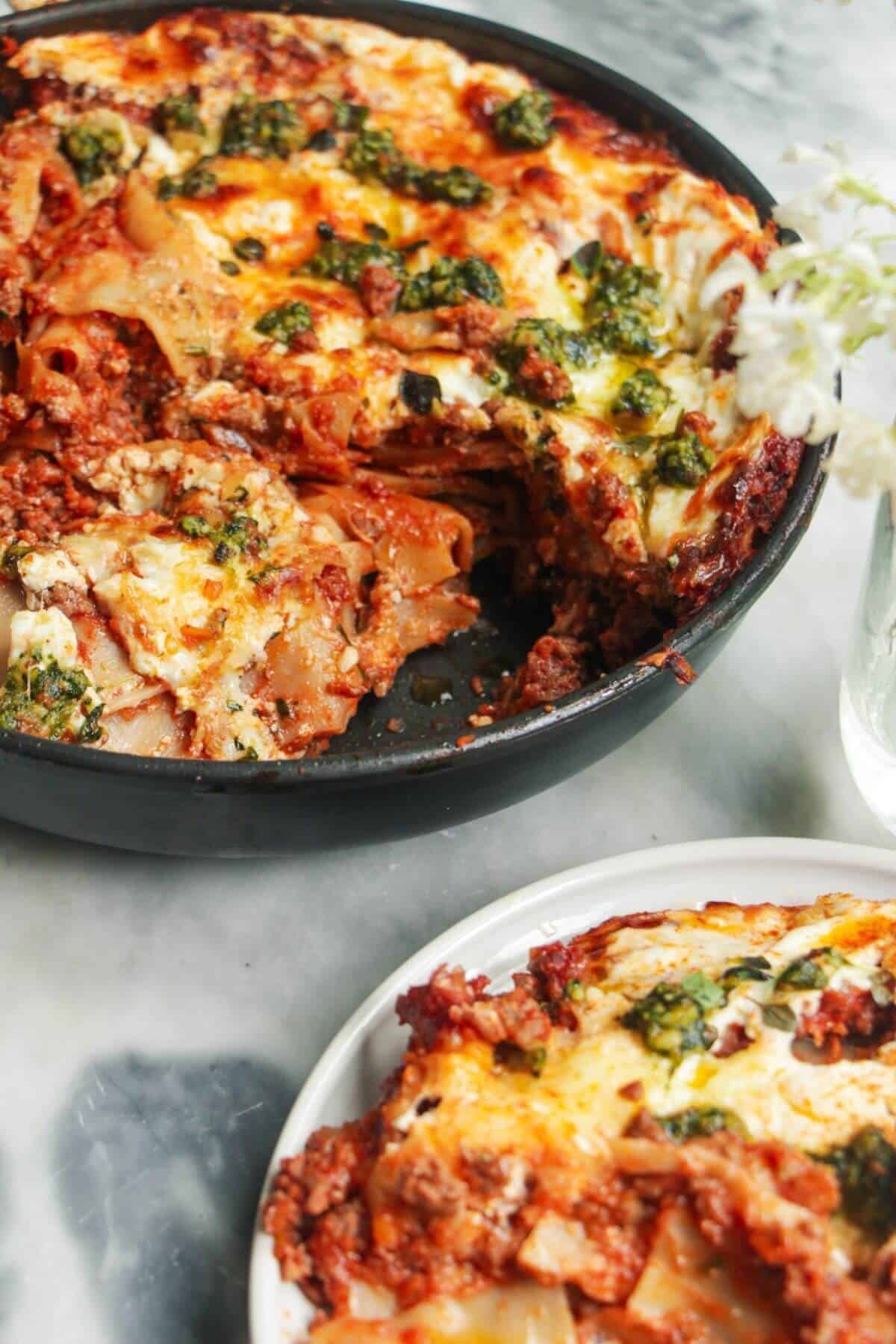 Side view of layers in one pot lasagna in a small black pan.