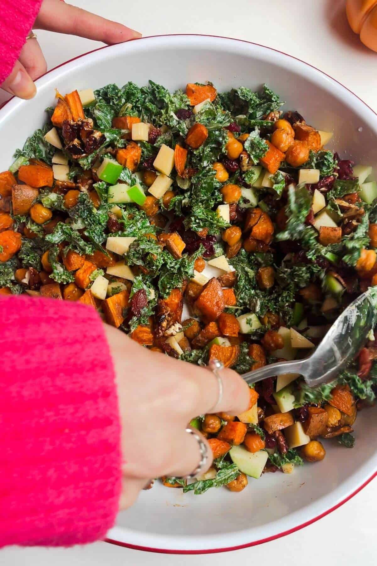 Mixing salad ingredients in a bowl.