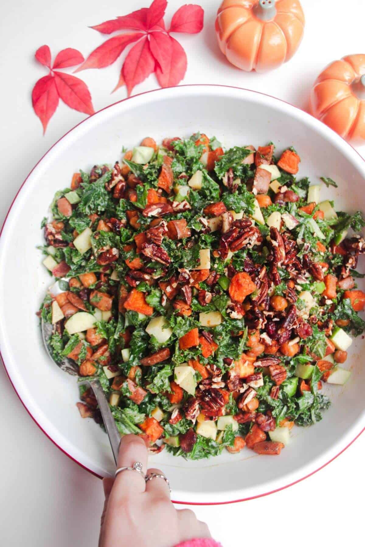 Sweet potato and kale salad in a white serving bowl.