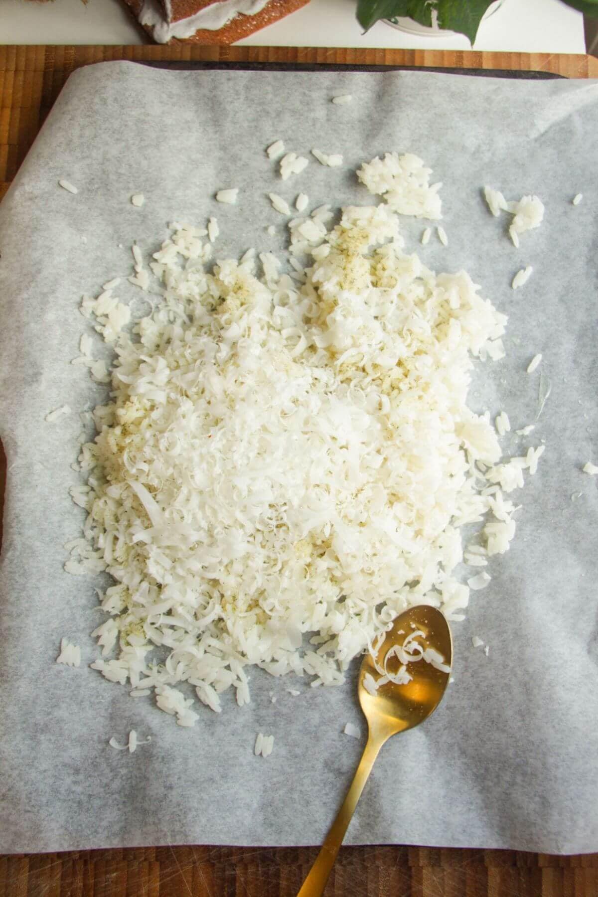 Parmesan, ranch and olive oil on rice on an oven tray.