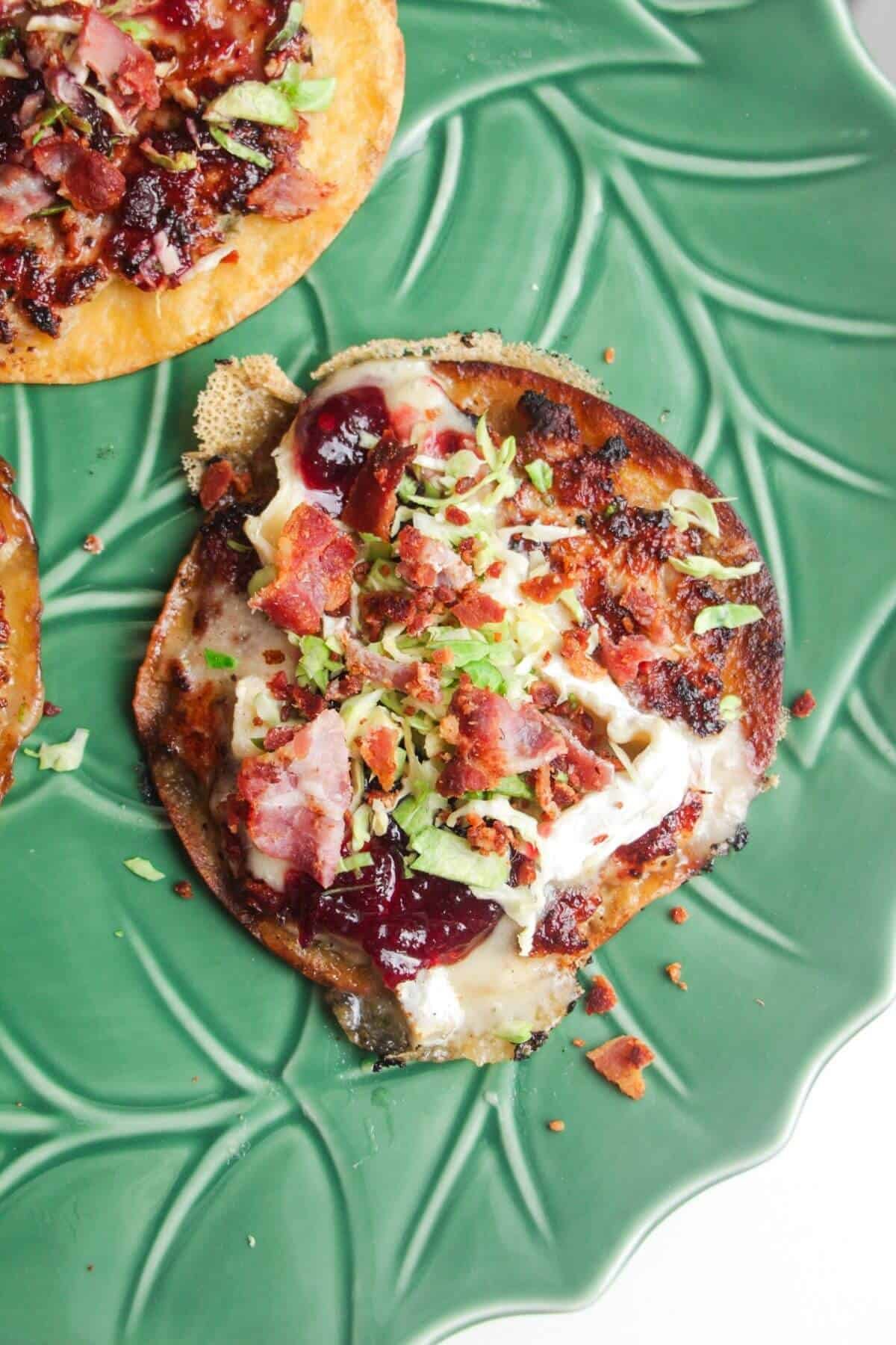 Festive taco topped with bacon, cranberry sauce and brussel sprouts.