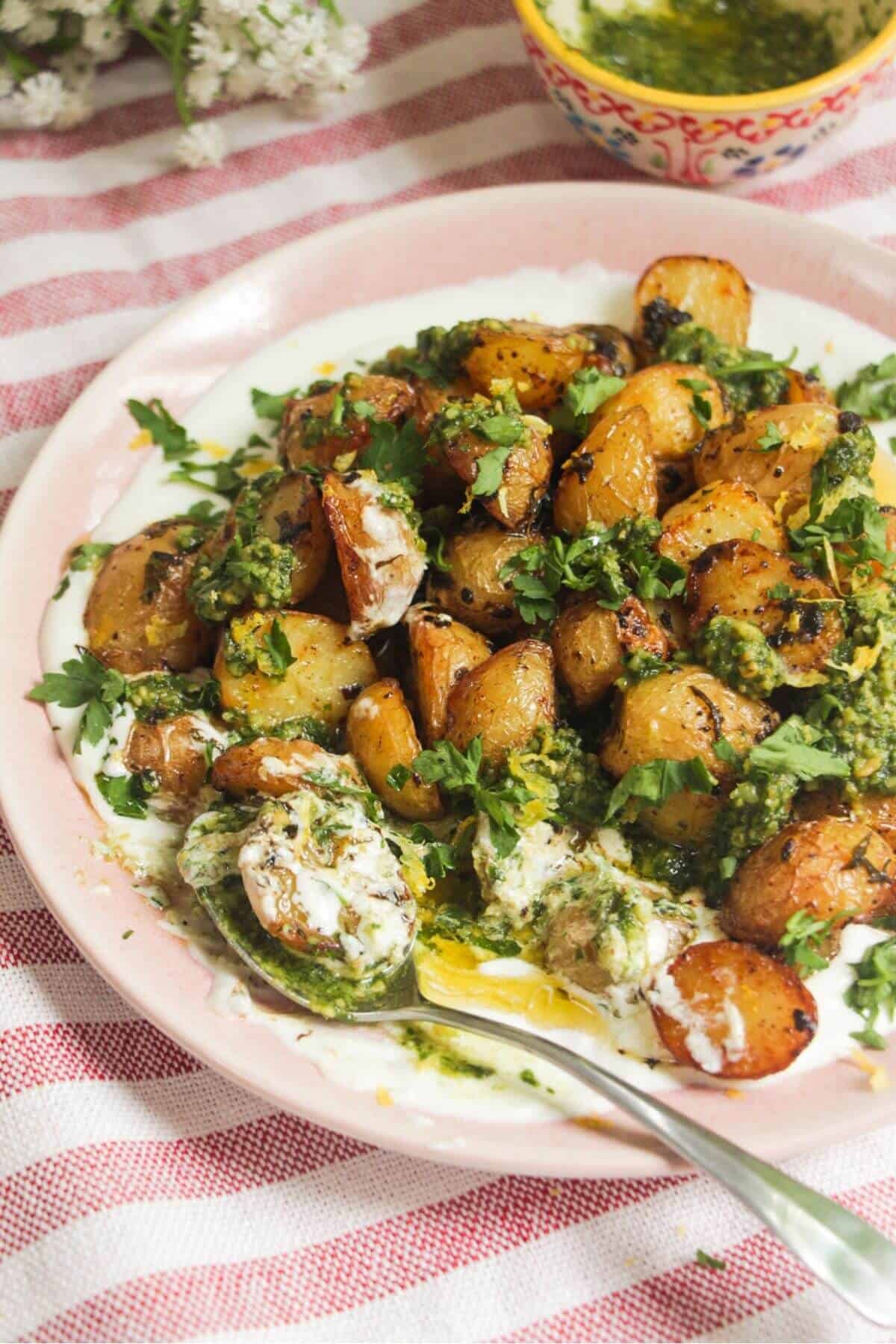 Garlic butter potatoes on top of creamy whipped feta and topped with pesto.