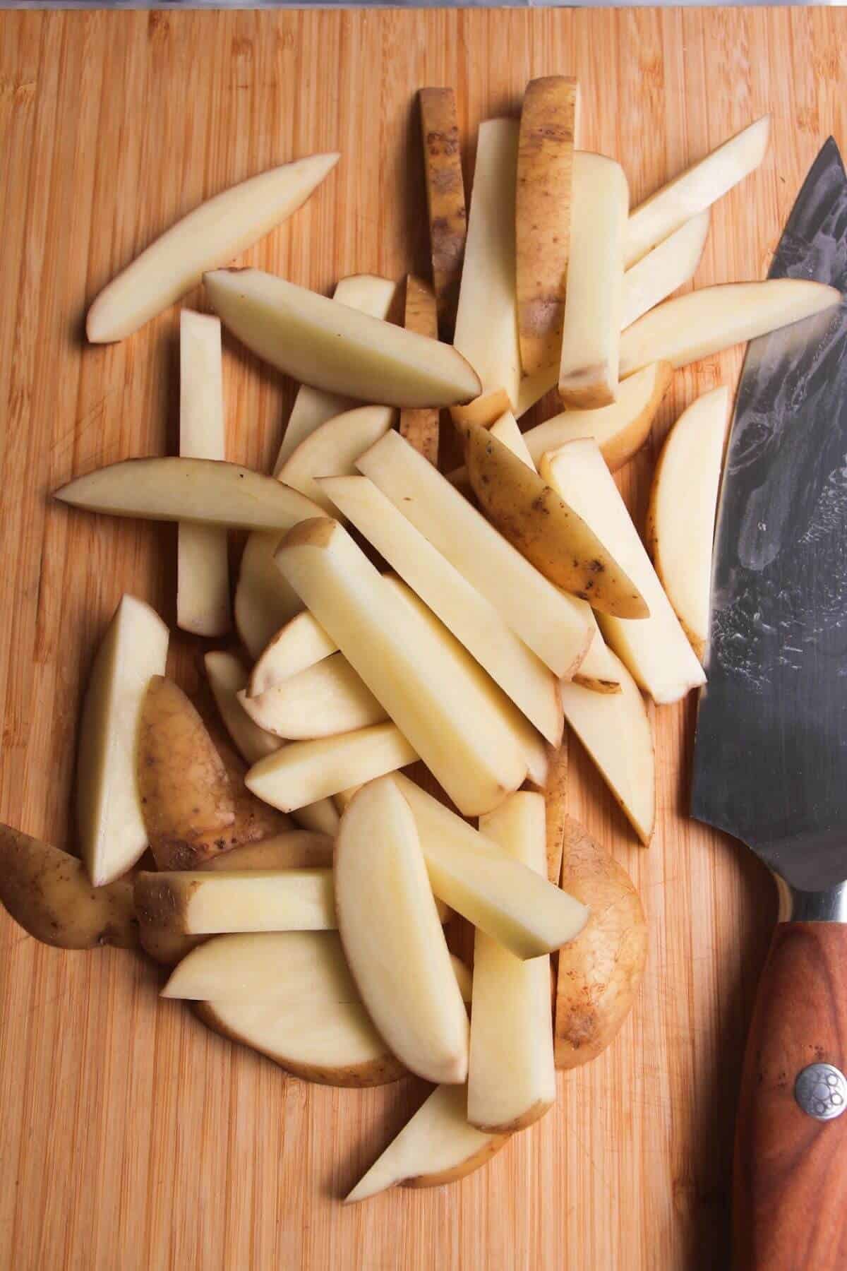 Sliced chips on a wooden board.