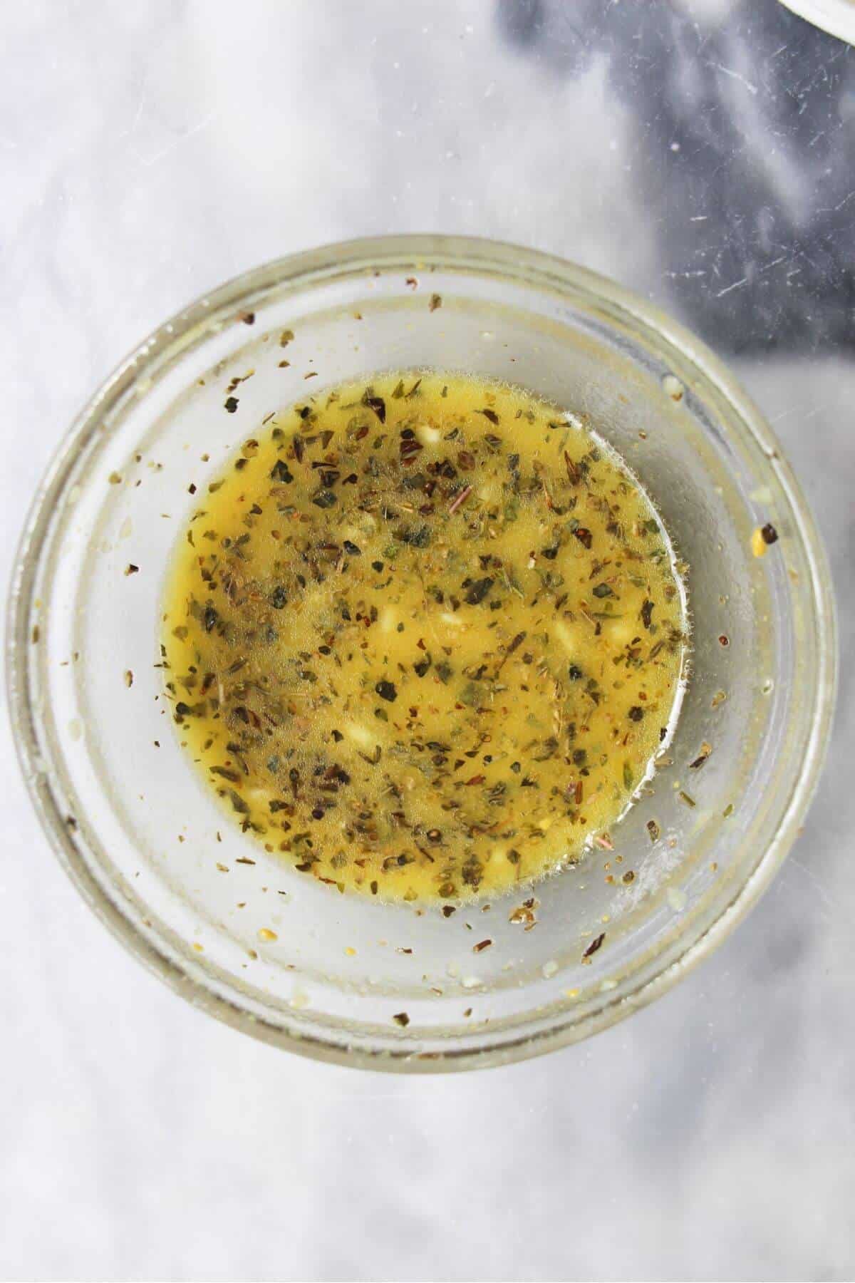Dressing mixed in a small glass bowl.