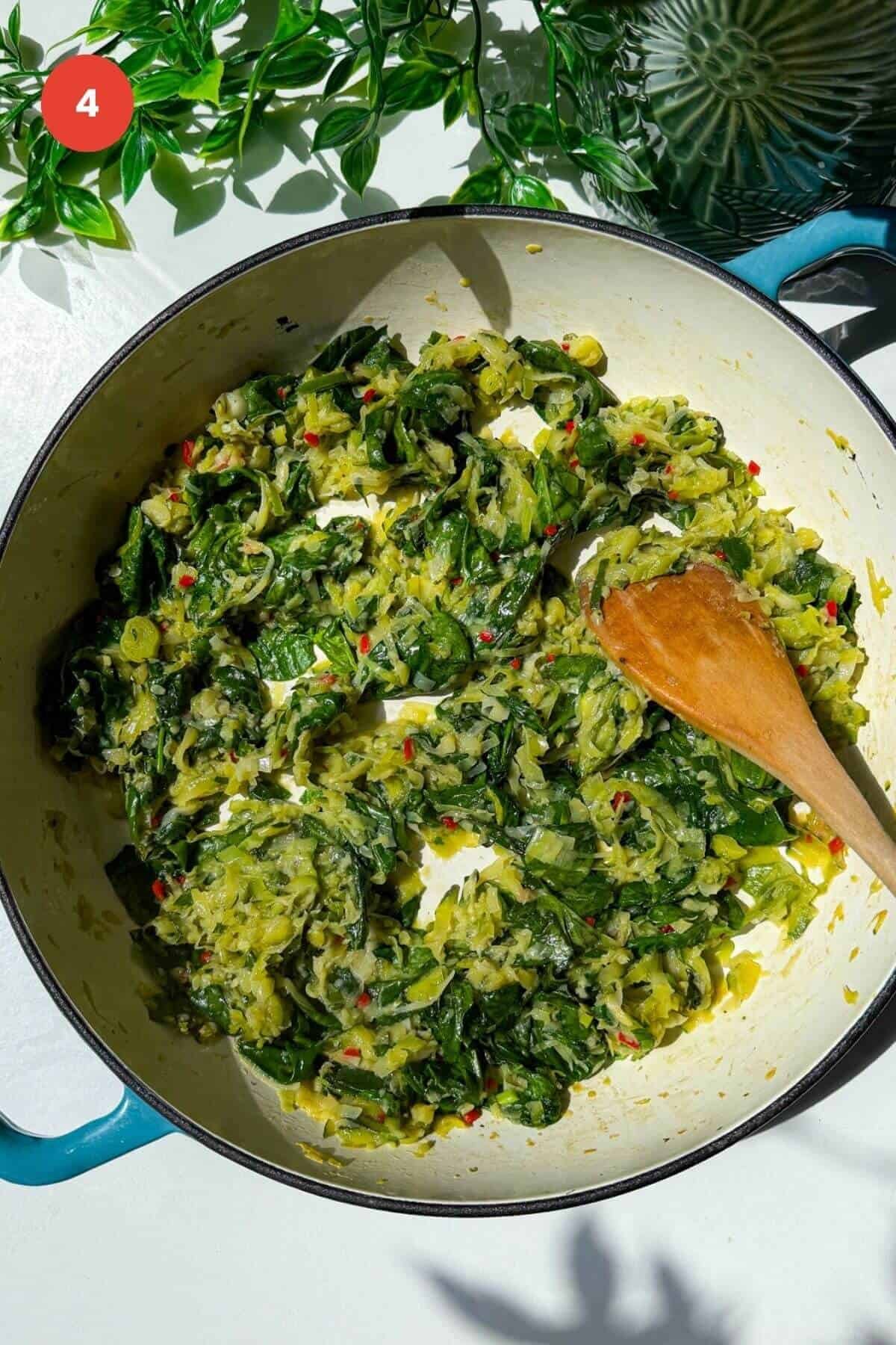 Greens cooked down in a skillet.