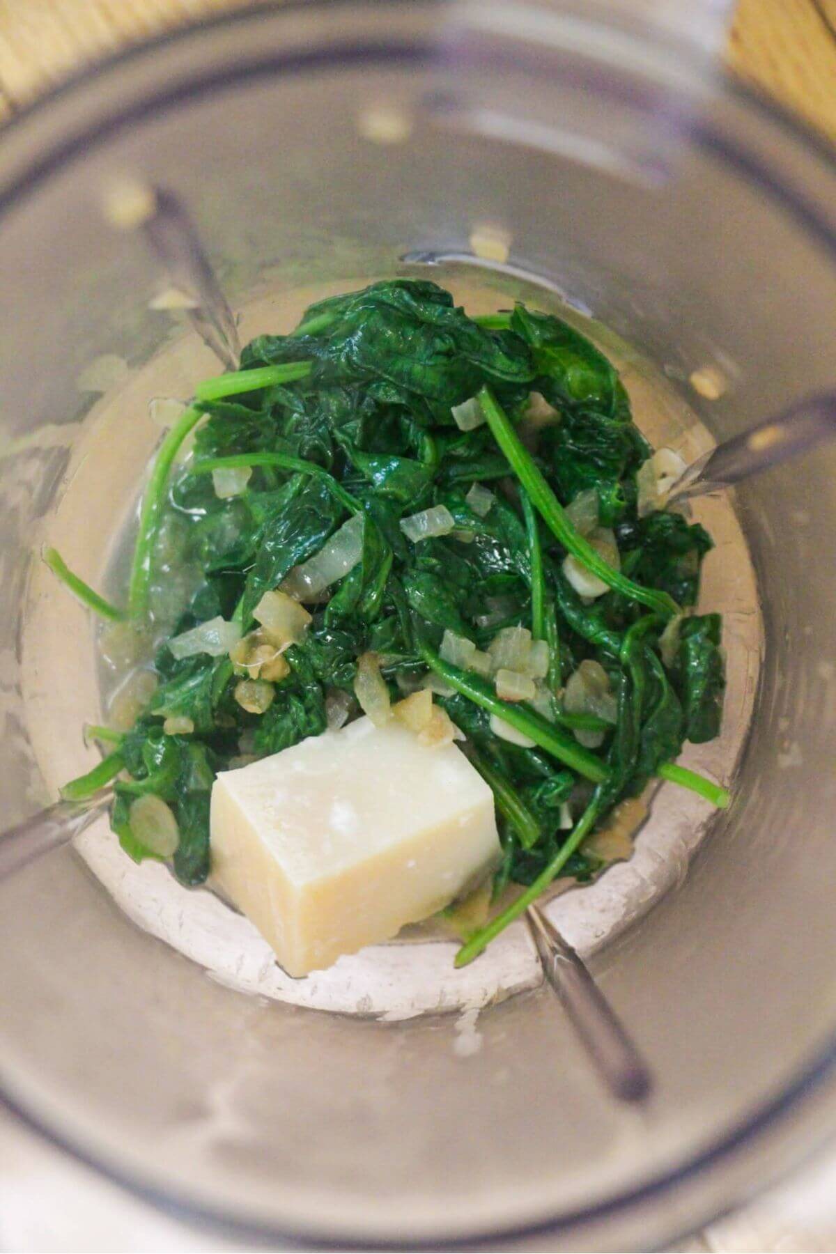 Green pasta sauce ingredients in a blender ready to be blitzed.