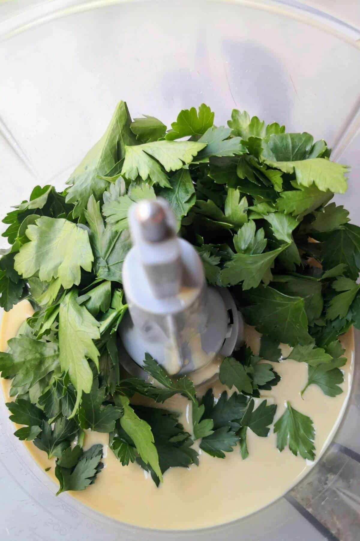 Parsley, tahini, lemon juice, garlic and salt in the bowl of a food processor.