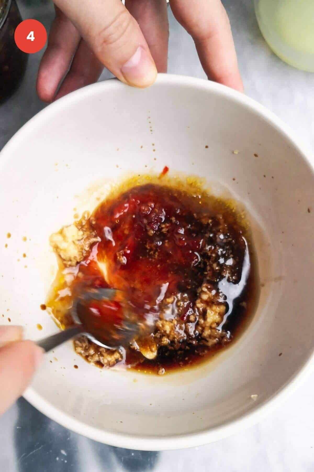 Mixing miso dressing in a bowl.