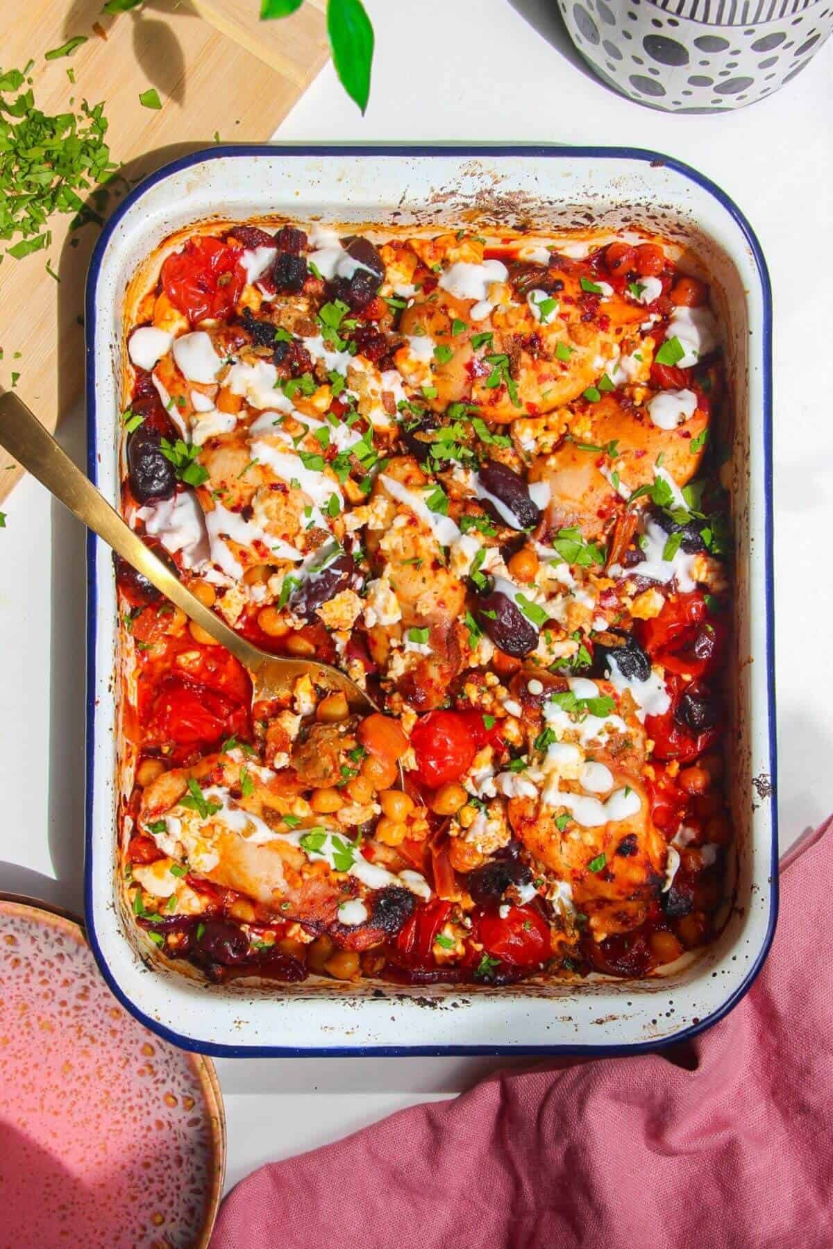 Harissa chicken baked with tomatoes, feta and chickpeas.