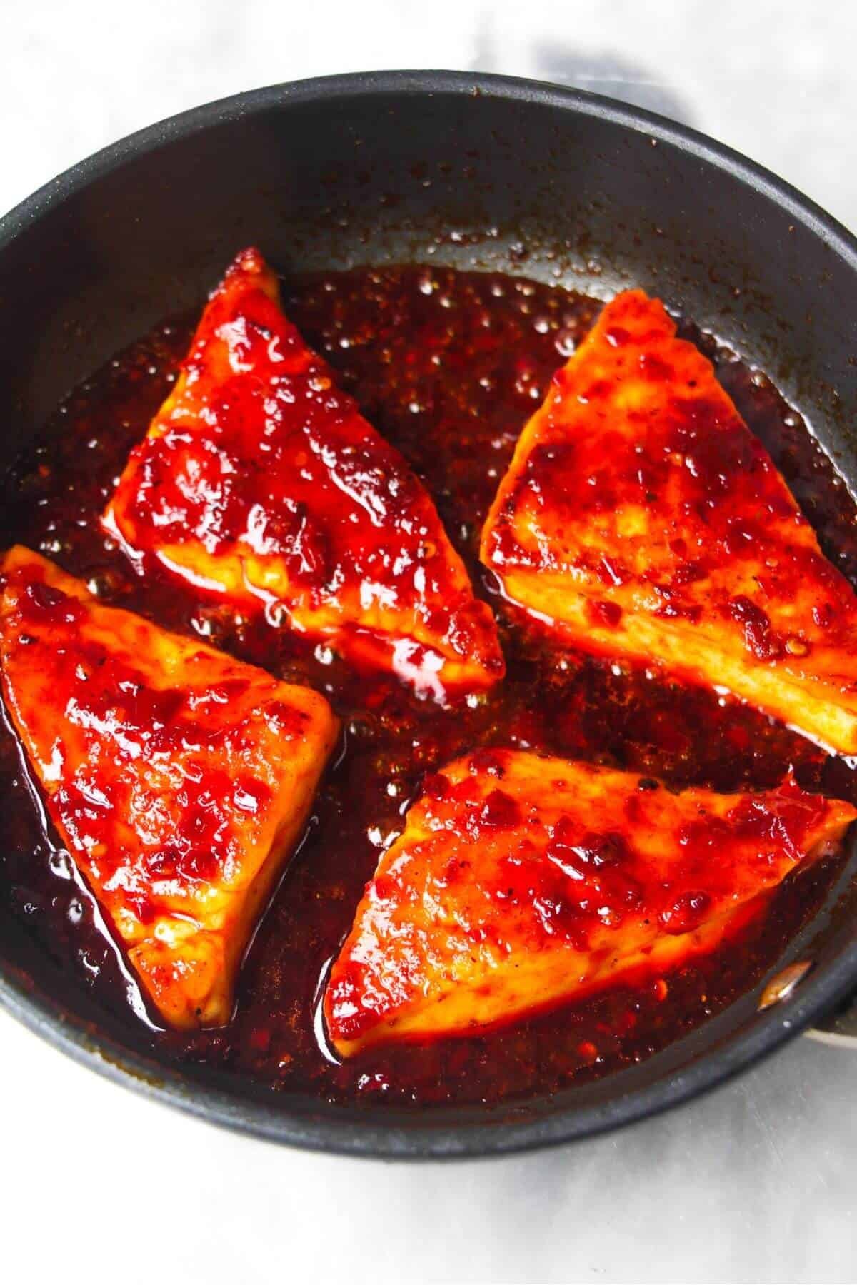 4 wedges of halloumi tossed through red honey harissa sauce.