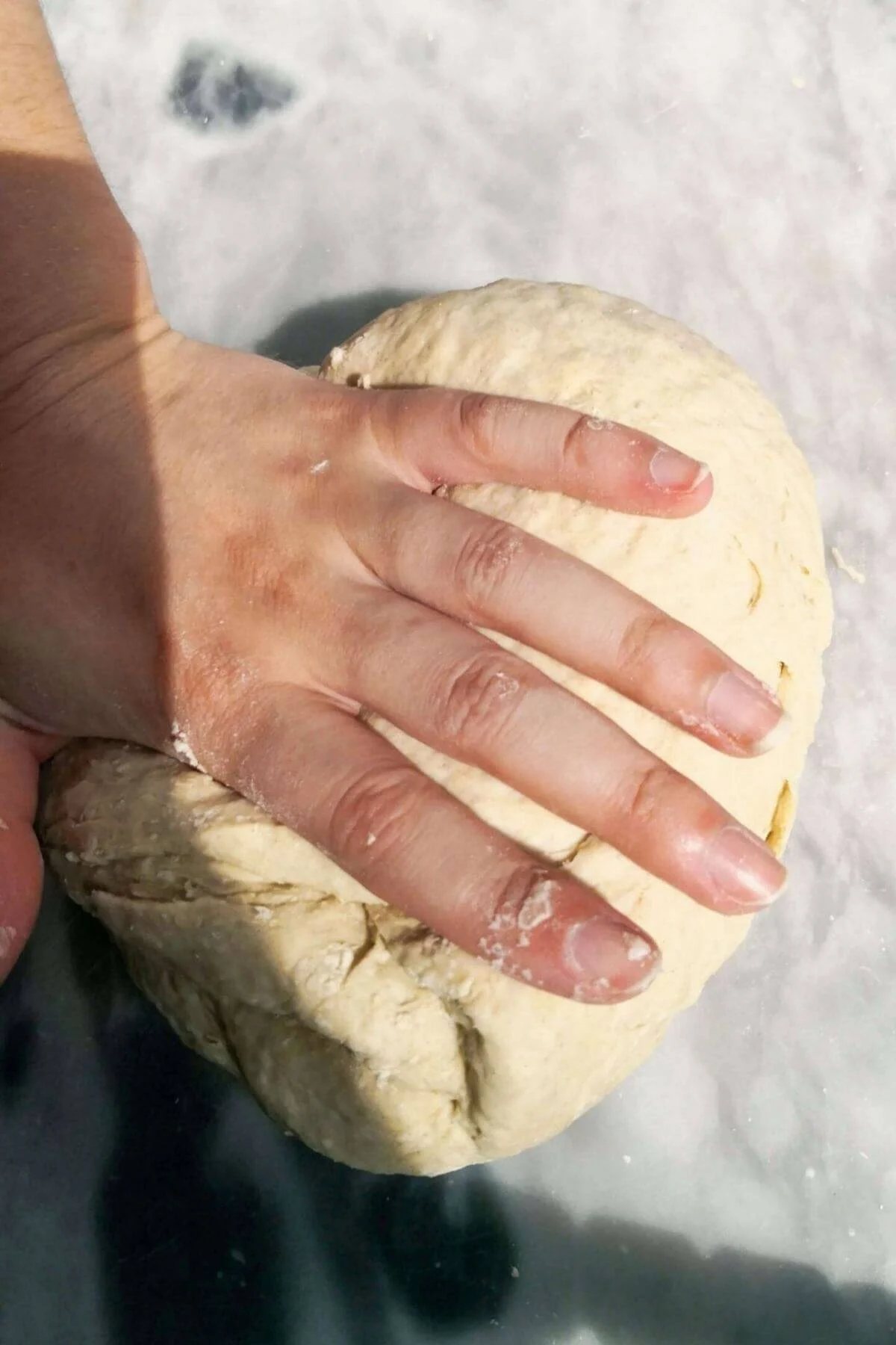 Folding dough over itself.