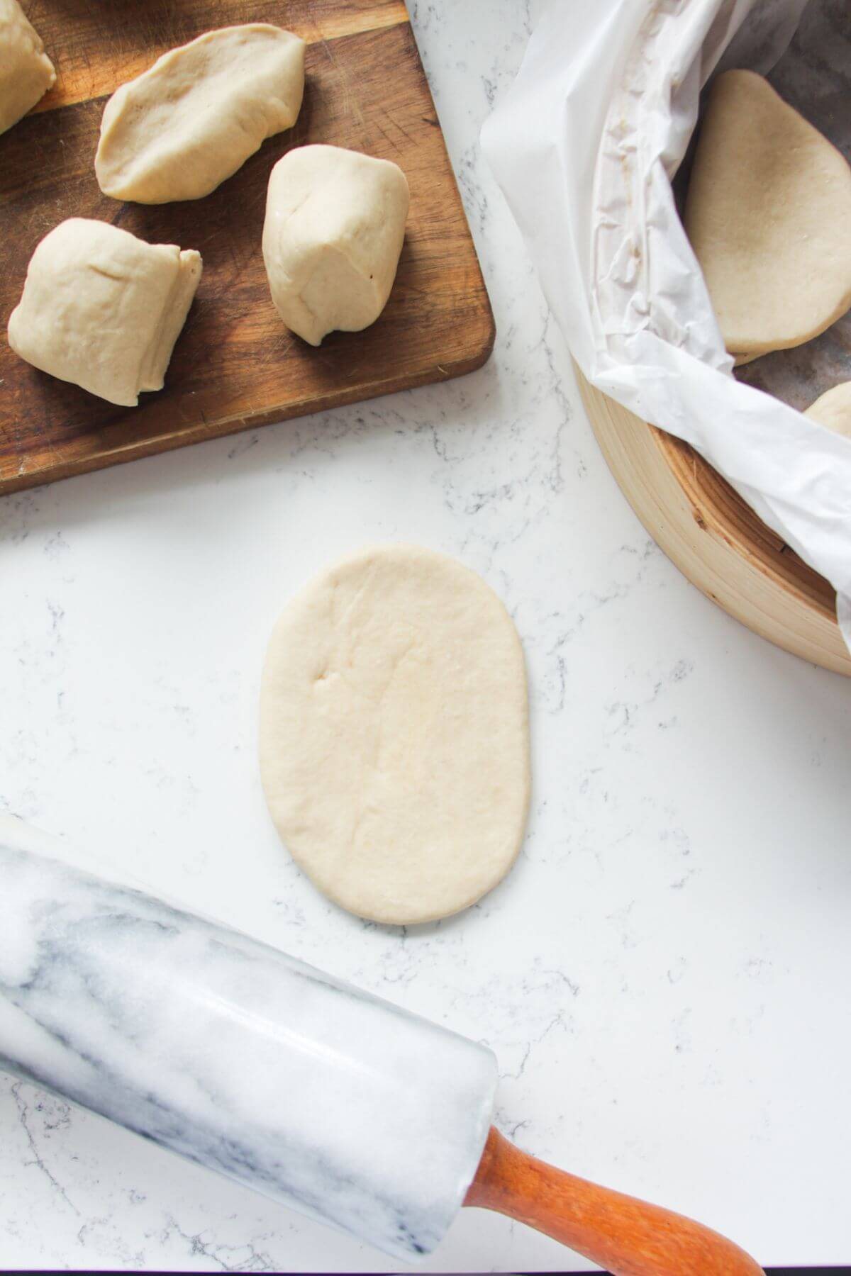 Oval of bao dough rolled out.