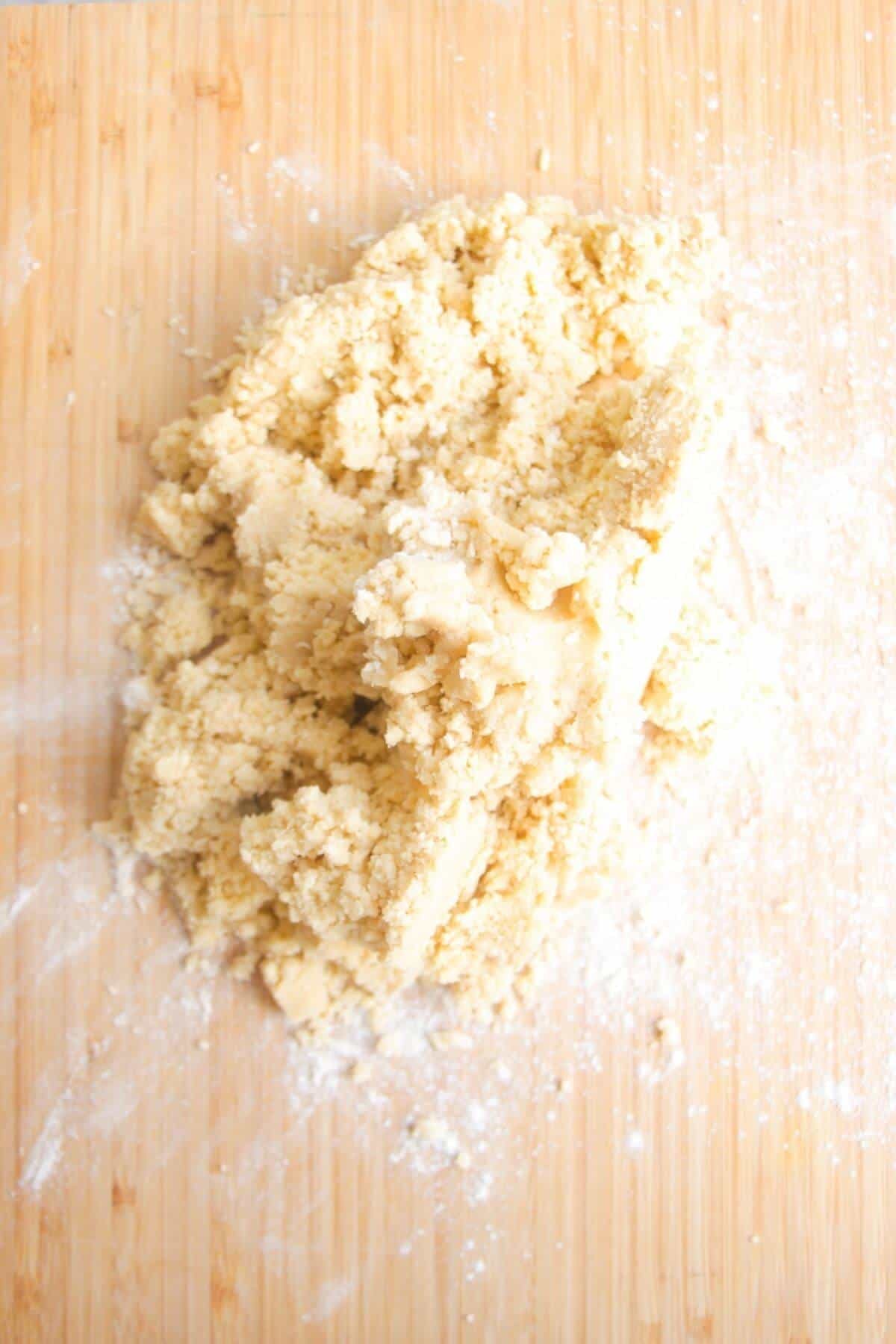 Blitzed pastry laid out on a wooden board.