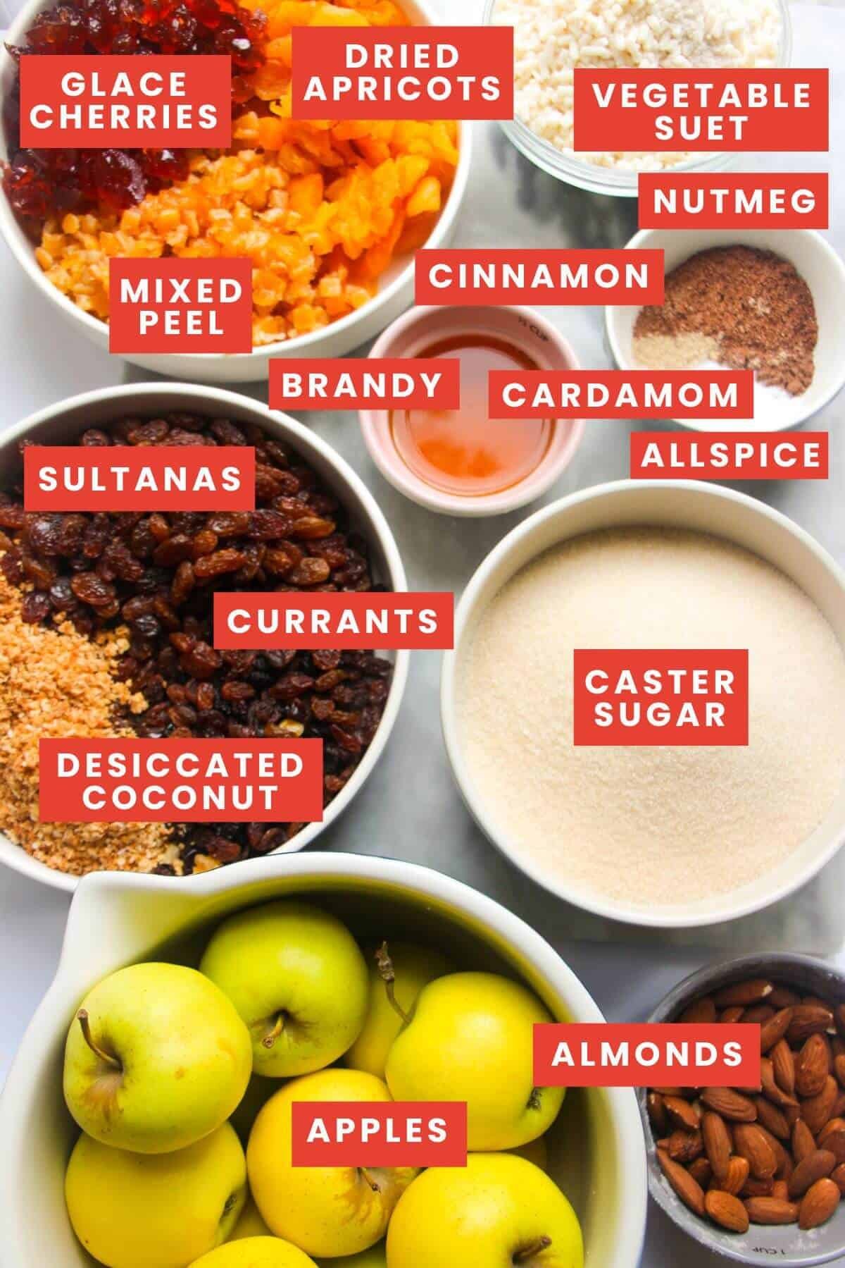 Ingredients for fruit mince laid out on a grey marble background and labelled.