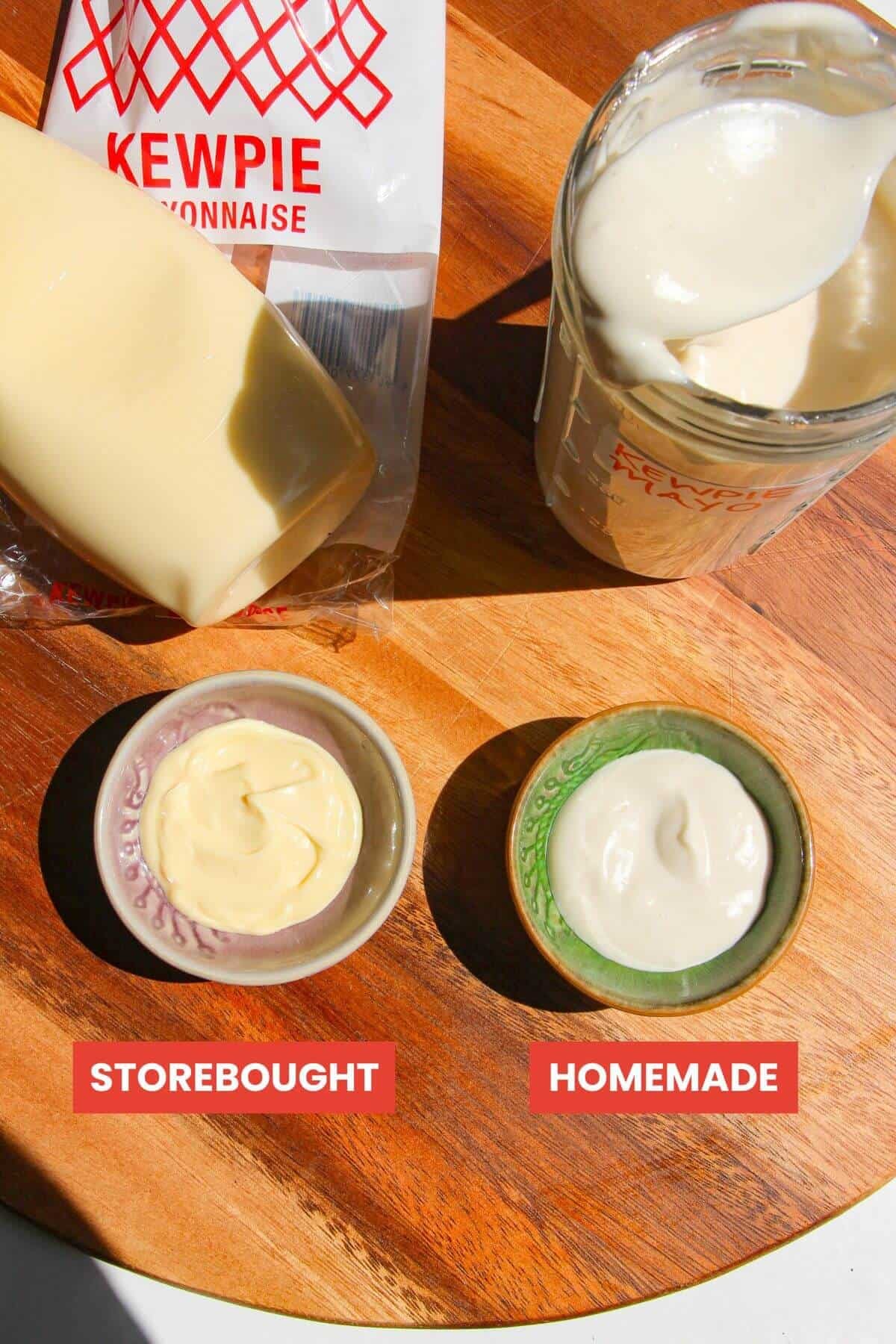 Storebought Kewpie mayo in a small bowl next to homemade mayo in a small bowl.