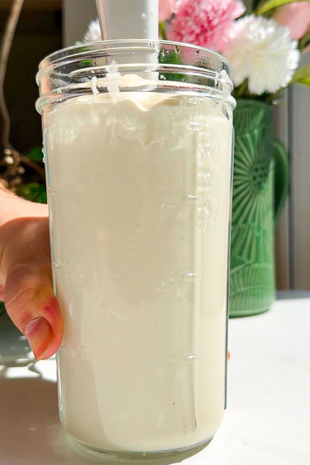 Kewpie mayo blended in tall glass jar.