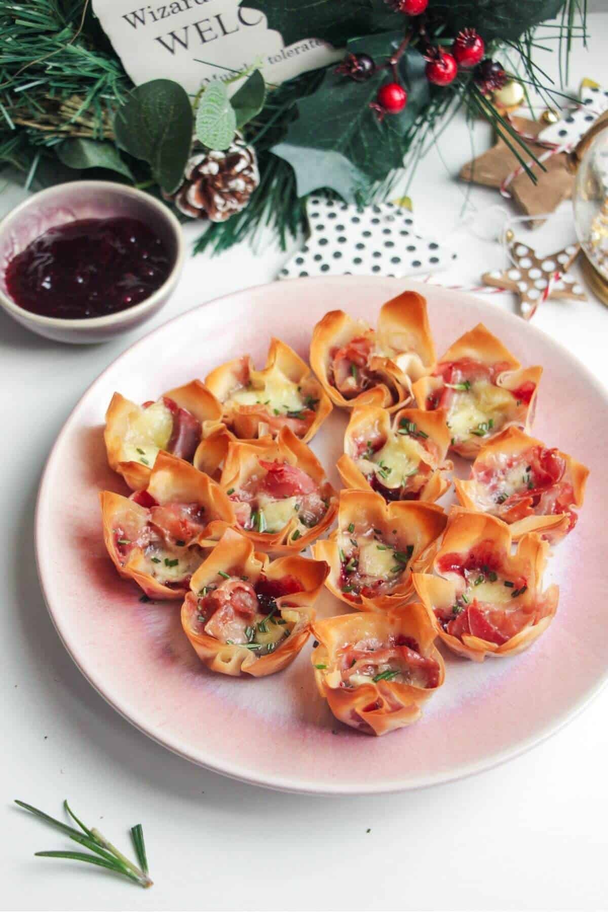 Brie filo bites on a small pink plate.
