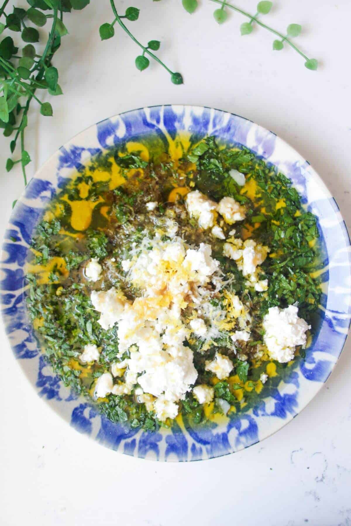 Jalapeno popper bread dipping oil on a blue and white patterned plate.