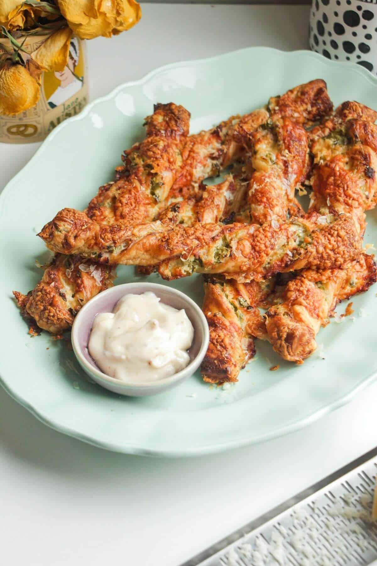 Cheese jalapeno popper straws on a blue plate.