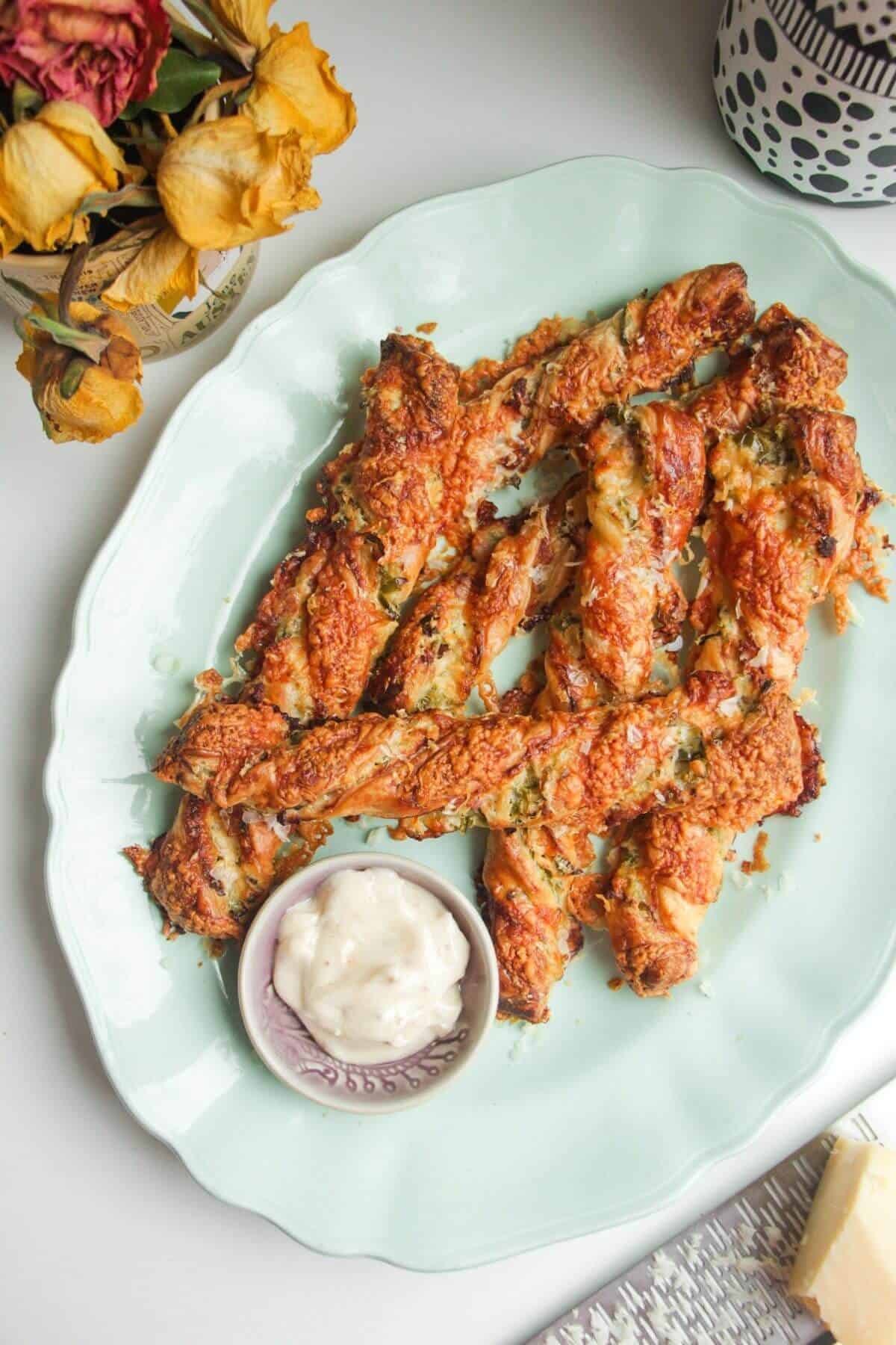 Cheese jalapeno popper straws on a blue plate.