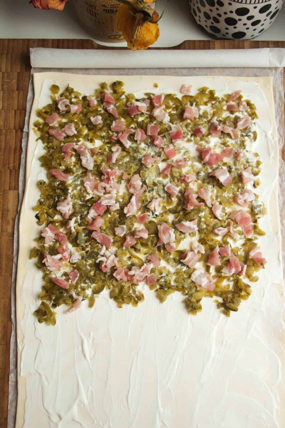 Chopped jalapenos and bacon on top of puff pastry.