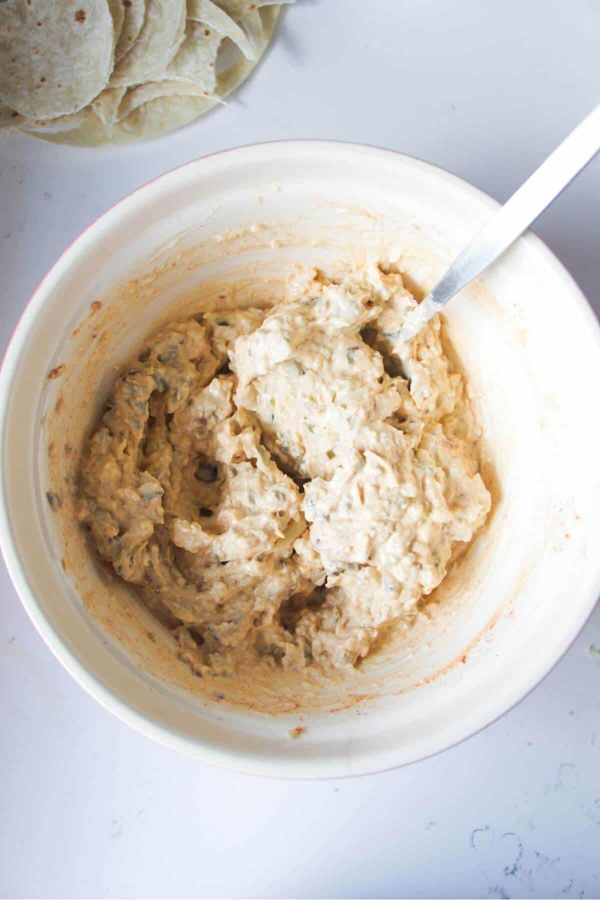 Jalapeno popper dip mixture in mixing bowl.