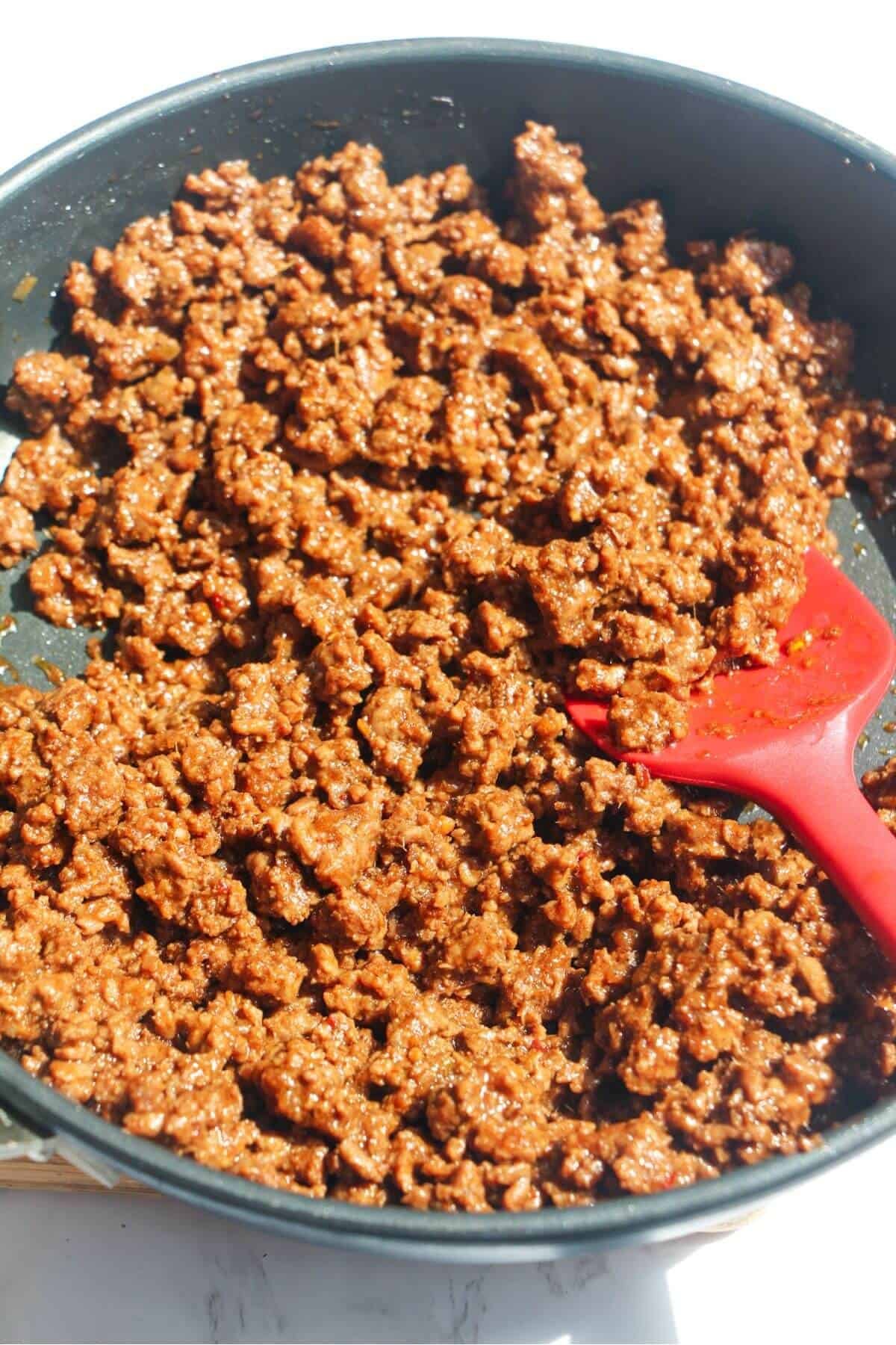 Sticky Korean beef with sauce mixed through in a frying pan.