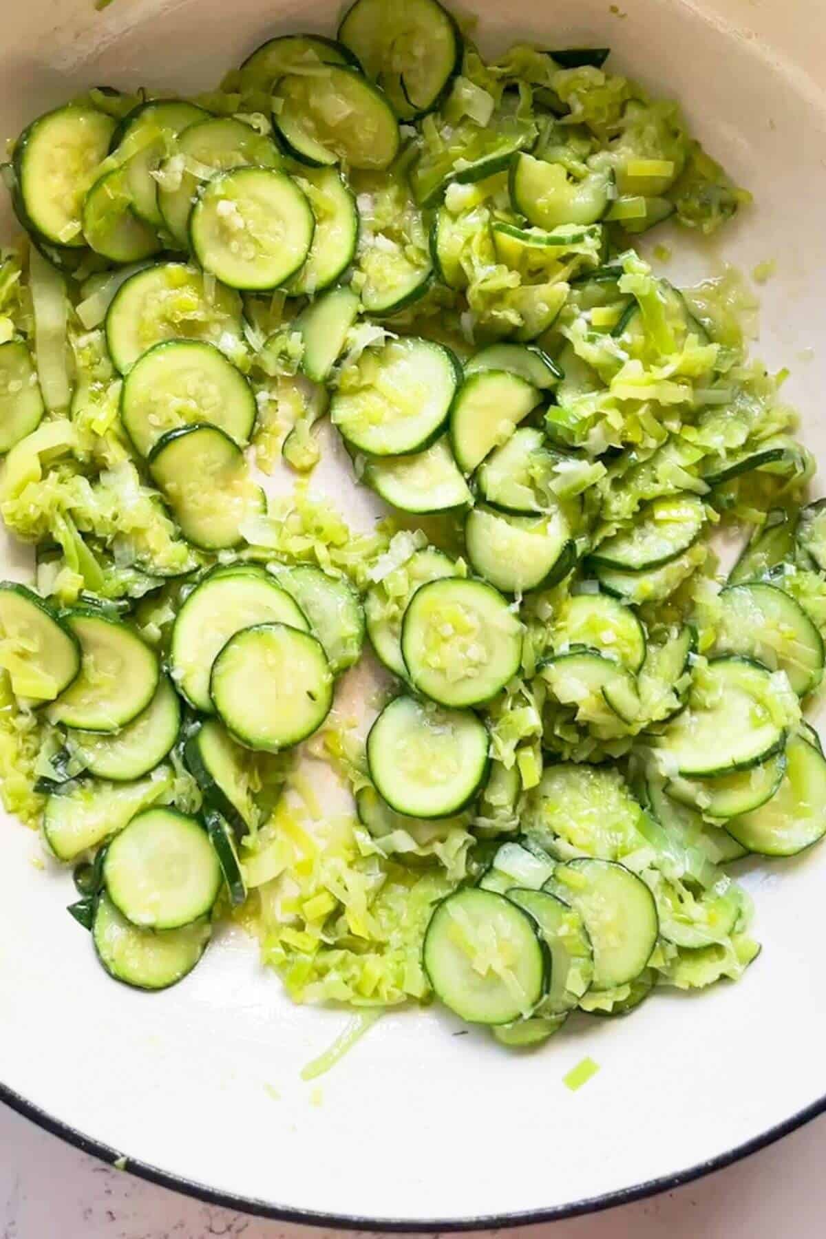 Softened sliced zucchini and leeks in a large pot.