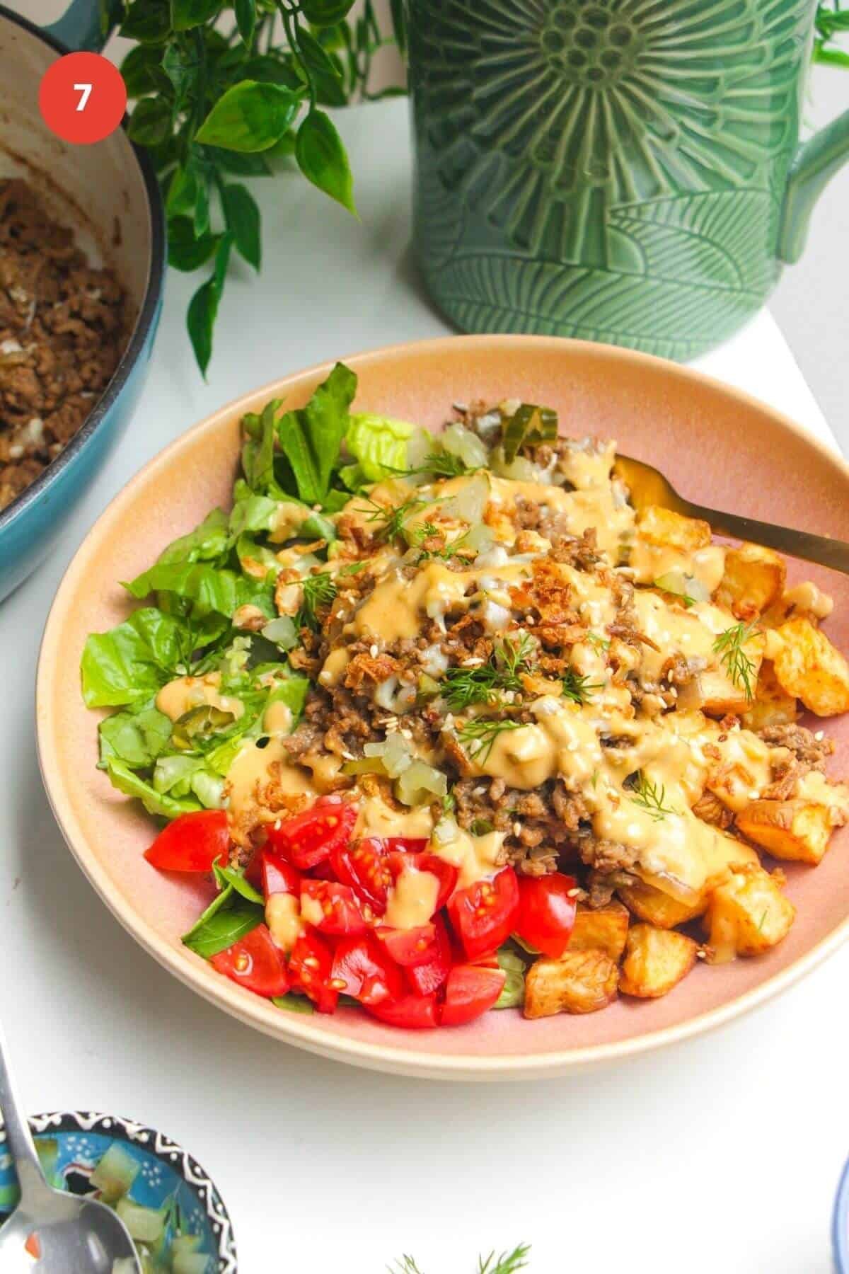 Loaded cheeseburger bowls drizzled with burger sauce.