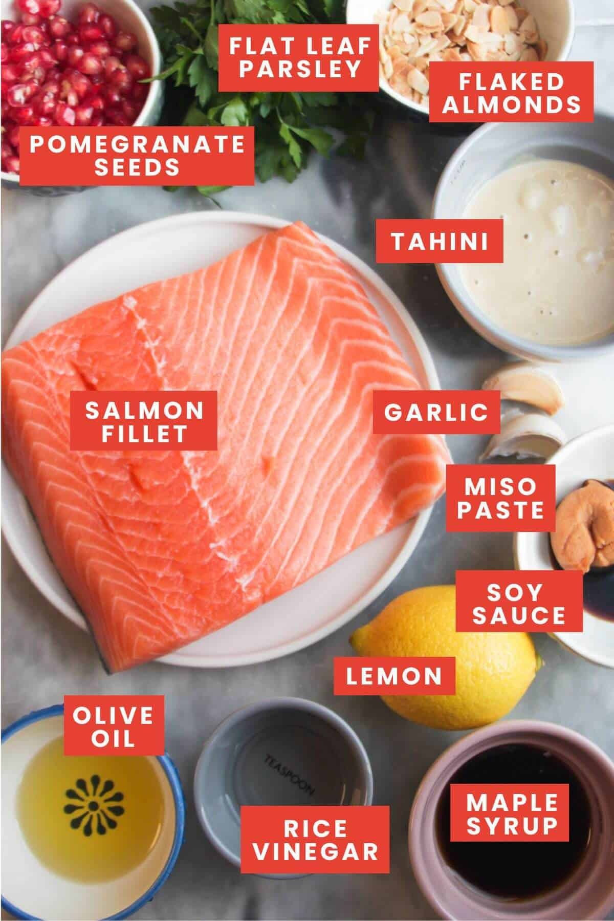 Ingredients for maple miso salmon on a grey marble background and labelled.