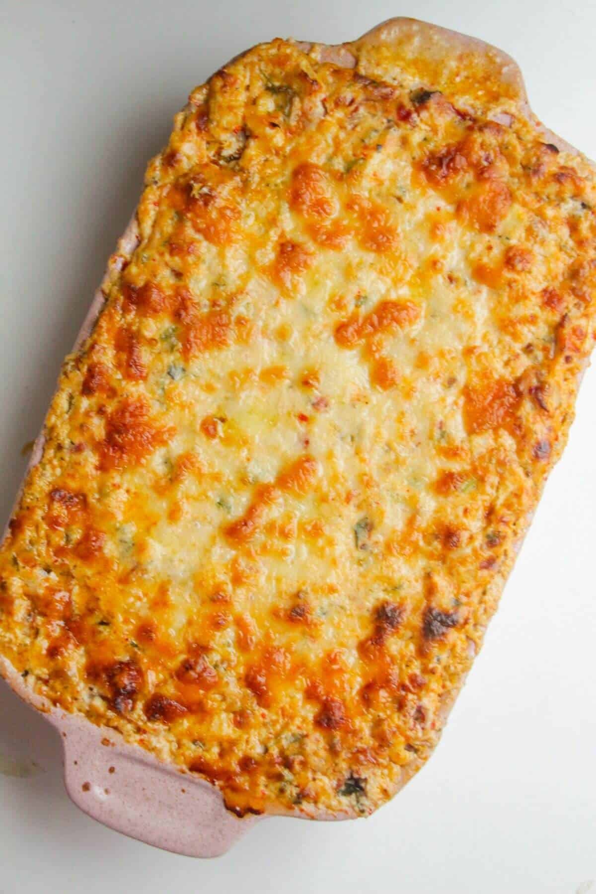 Cheesy baked Marry Me chicken dip in a small oven dish.
