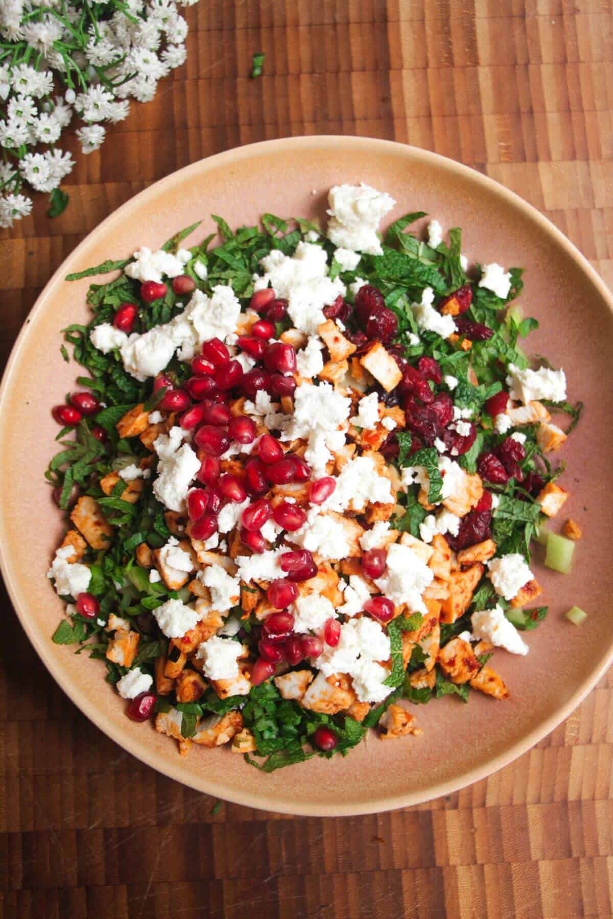 Ingredients for Mediterranean crispy rice salad in pink bowl.