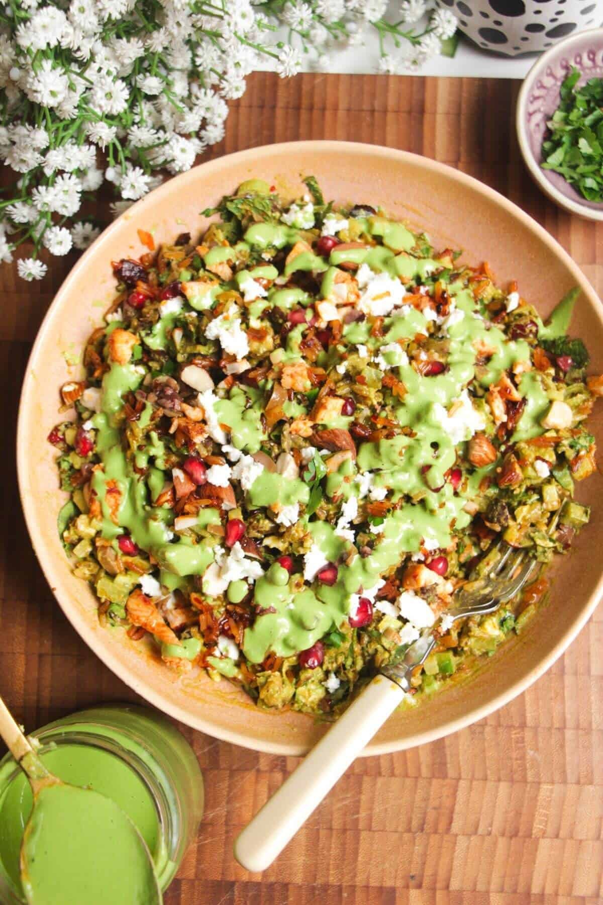 Mediterranean crispy rice salad in a pink bowl.