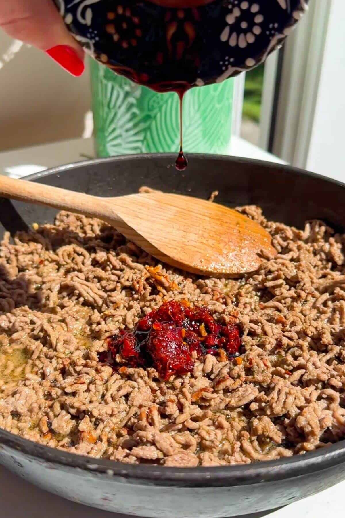 Harissa paste and seasoning added to ground beef.